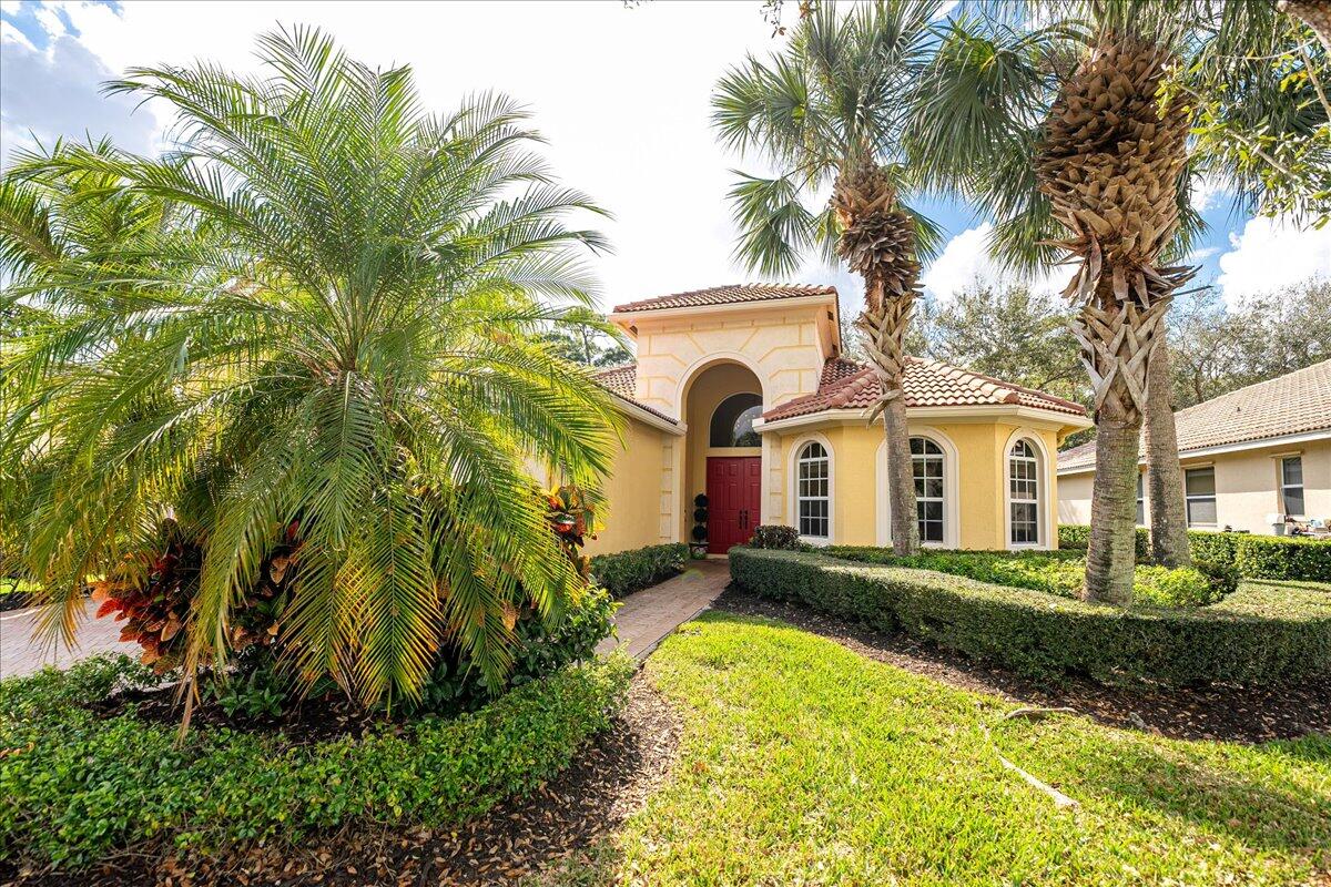Tee up your Florida lifestyle at 8821 Champions Way in the prestigious PGA Village.Fully furnished and move-in ready, this 3 bedroom, 3.5-bath home offers over 2,300 sq. ft. of bright, open living space overlooking the golf course. Step outside to your private solar-heated, screened-in pool with cabana bath, or fire up the brand-new outdoor kitchen--complete with sink, ice well, grill, and granite seating for six--perfect for post-round gatherings.Inside, soaring 15' ceilings, oversized 12' sliding glass doors, and tile flooring throughout create a light, airy feel. The chef's kitchen boasts granite countertops, 42'' cabinets, and stainless-steel appliances, while the spacious primary suite features dual sinks, a soaking tub, and a separate shower.