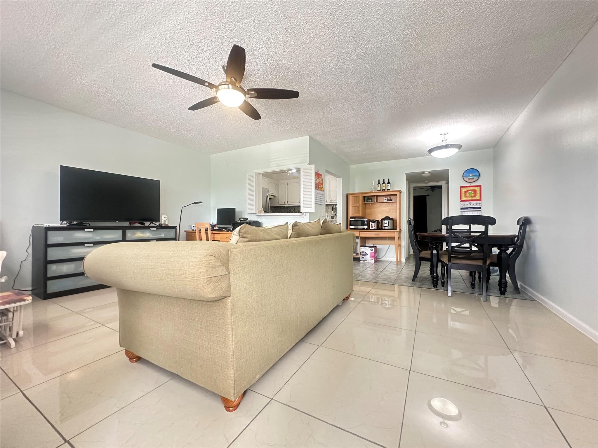 GREAT PRICE for this 1 bedrm, 1.5 bath on the 2nd flr. (with lift) in the very desirable active community of Century Village! Features incl SS appliances & tile backsplash in kitchen, ceramic tile flrs thru-out, tub/shower in primary bathroom, 5 ceiling fans & enclosed patio with a portable A/C & closet overlooking nice garden view. Unit comes fully furnished! Building has a new roof & attic! Bus stop in front of bldg. and close to West Gate for easy access. Enjoy resort style living in this 24/7 Gated community w/free bus service, tennis, pools, putting green, pickle ball, 5 star world class Clubhouse w/3000 seat Theater, fitness cntr, clubs, classes, indoor & outdoor pools, billiards, Minutes to the Beach, shopping & Restaurants. DON'T MISS THIS GREAT OPPORTUNITY!!!! Assoc. claims 55+