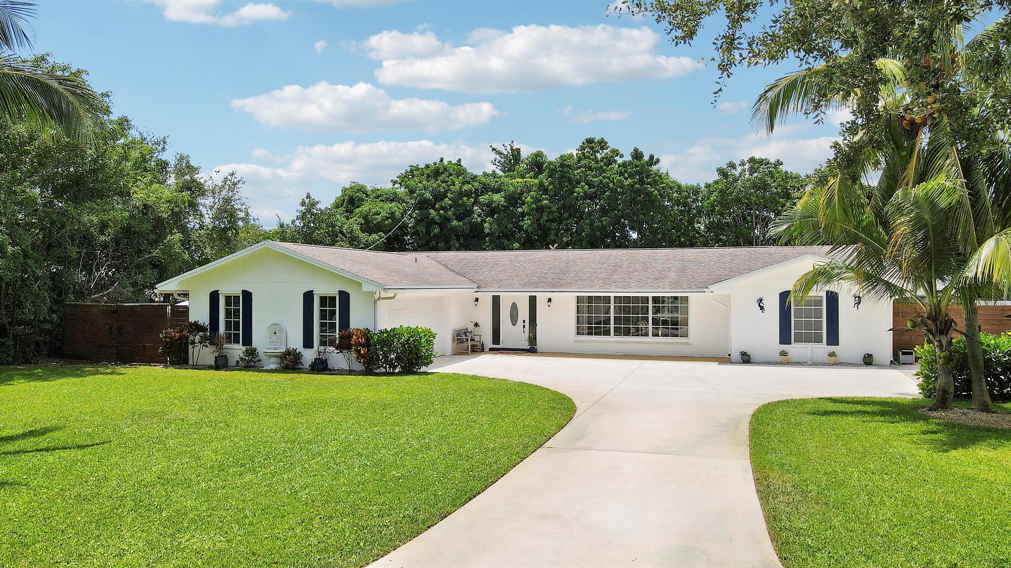 Welcome to 339 Country Club Drive, where South Florida living meets comfort and style.This spacious CBS home features 4 bedrooms, 2 baths, and a 2 car garage, ideal for those seeking a versatile living space. Situated on a generous lot, the property includes a large side yard perfect for parking your boat and offers complete hurricane protection.Inside, the home is bright and inviting, with new flooring, a kitchen that is equipped with newer appliances, quartz countertops and features a large pantry, perfect for all your storage needs. The large kitchen window and two sliders provide stunning views of the outdoor space including a resurfaced pool and private, fully fenced backyard.The home offers a split floor plan with an interior laundry room and the primary