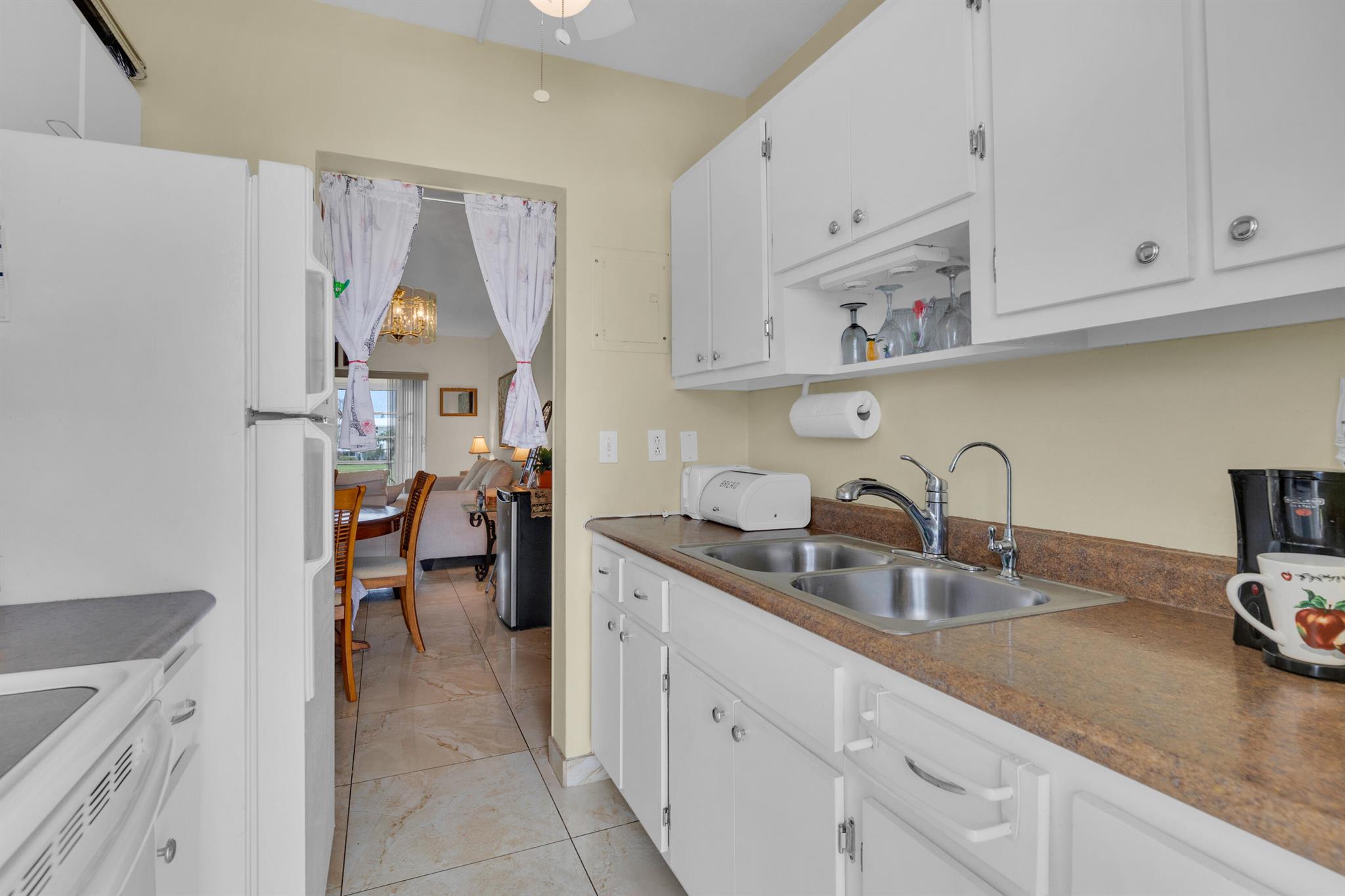 Pompano Beach 2 BR/1 BA with gorgeous views of Private Par 3 Nine Hole Golf Course. East of I95. Condo roof 2013, HOA fee includes Common Areas, scheduled activities, 2 pools FREE RESIDENT GOLF. 2 clubhouses, Beautiful Title floors thru out. 1 Car Parking. Rent after 2 yrs. Priced to SEll. Close to Casino, minutes to 3 beaches. Close to Pompano Beach Redevelopmnet. Hourse Racing. This condo has a Land Lease of $163 / month. Cash only sale.