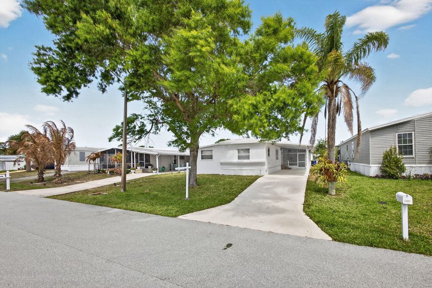 OWN THE LAND - NO HOA - 5 MIN TO BEACH! Own your lot in Hobe Sound with NO HOA! This clean, move-in-ready 2BR+office (or 3rd BR) features a split plan with a bath on each end. The spacious kitchen offers an eat-in center island with granite countertop, stainless appliances, and a Reverse Osmosis water system. Includes separate dining, interior laundry with front-load washer/dryer, and a large screened-in porch.  A private well for sprinklers and no homes in front provides a quiet, open view—perfect for pets. Ideally located steps from Jimmy Graham Park and the public boat ramp, and just 5 mins from Hobe Sound beach. Plenty of storage with an inside utility room and outside shed. Optional pool/clubhouse membership available.