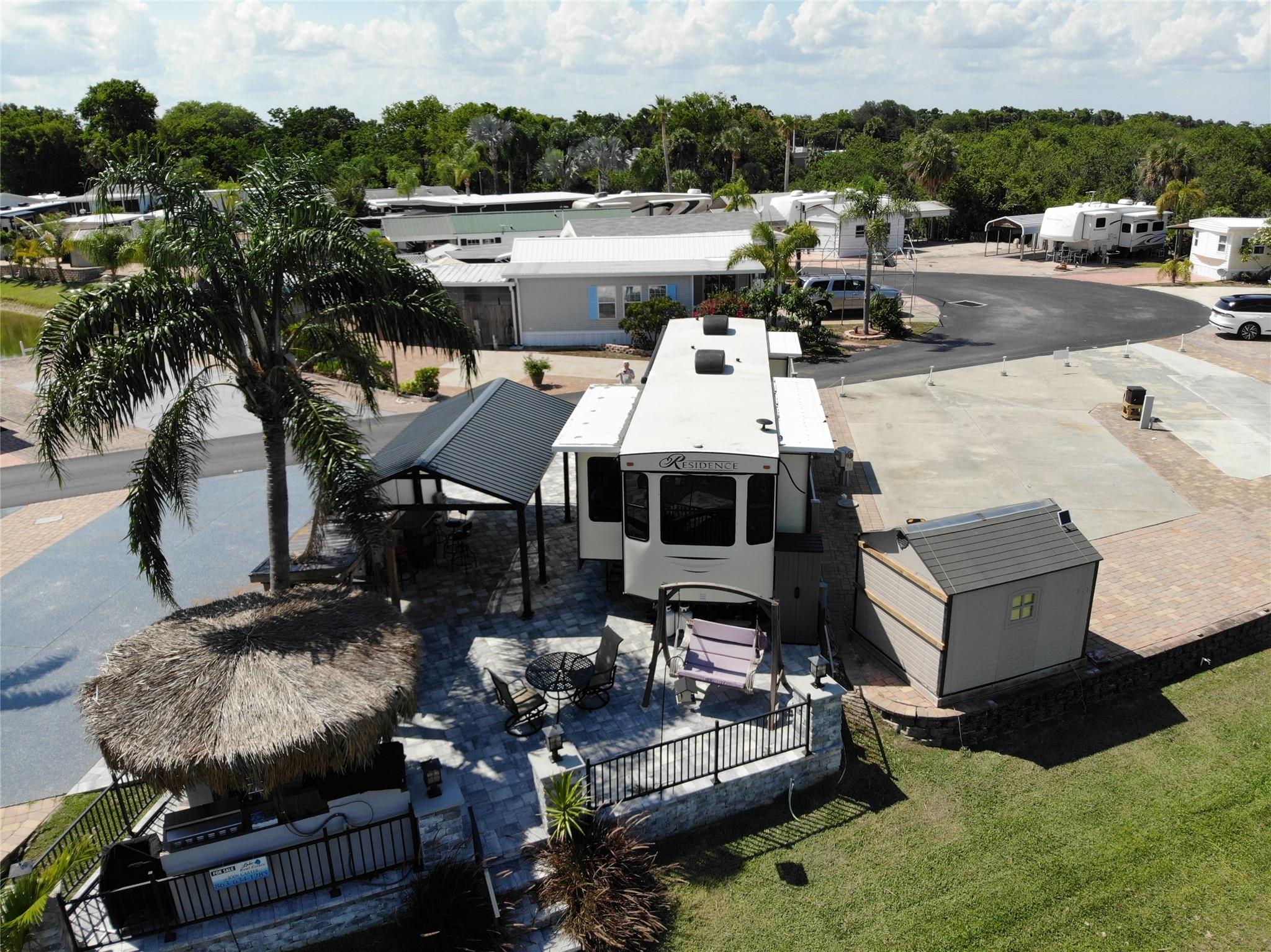 ~Big O RV Resort~ 55+ Community. Gorgeous Lot #51 on the Rim canal w/ 2019 40Ft cottage/Residence by Keystone. Laminate flooring, Queen bed- washer & Dryer inside. Carport for the toys. Total outside area is beautiful gray payers, steps down to the canal with lighted matching columns in front & rear of property. BBQ/Party area with built in Tiki hut Bar. Lots of storage. Boat parking right out your steps. Privacy fencing runs down one side. Gated community. All measurements are approximate.