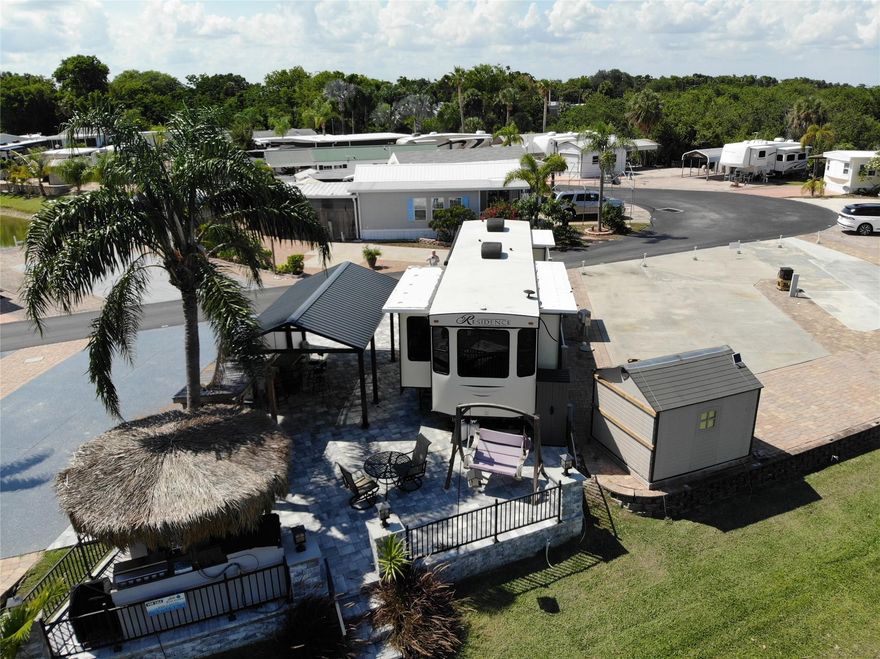 ~Big O RV Resort~ 55+ Community. Gorgeous Lot #51 on the Rim canal w/ 2019 40Ft cottage/Residence by Keystone. Laminate flooring, Queen bed- washer & Dryer inside. Carport for the toys. Total outside area is beautiful gray payers, steps down to the canal with lighted matching columns in front & rear of property. BBQ/Party area with built in Tiki hut Bar. Lots of storage. Boat parking right out your steps. Privacy fencing runs down one side. Gated community. All measurements are approximate.