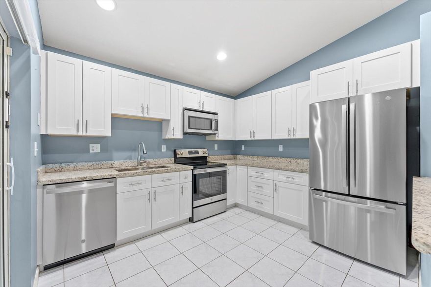 Welcome home to this beautifully updated 3-bedroom, 2-bathroom home located in the sought-after manned, guard-gated community of Regency Lakes-Eagles Cay, in fabulous Coconut Creek. Situated on an oversized cul-de-sac lot with a large fenced-in backyard, this property offers the perfect combination of privacy, comfort, and modern style. Step inside to discover updated kitchen and bathrooms featuring granite and quartz countertops, solid wood white shaker cabinets, new vanities, and newer kitchen appliances. The spacious primary suite offers dual sinks and a stand-up shower, providing a luxurious retreat. Enjoy Florida living year-round with a covered and screened patio featuring a new aluminum flat roof, perfect for entertaining or relaxing outdoors.