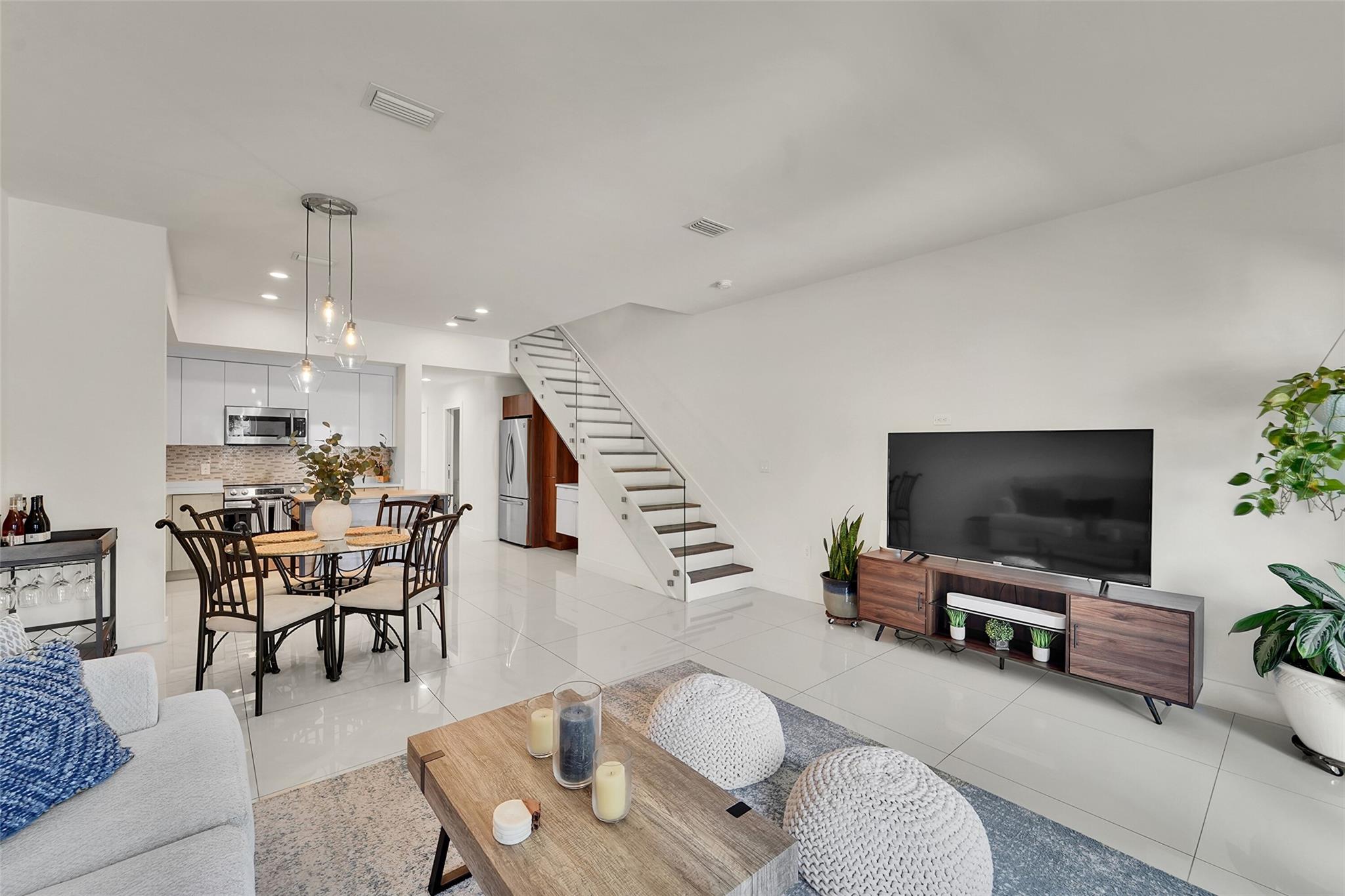 NEW DAWN TOWNHOMES, a boutique fee-simple community of 6 townhouse's nestled on the Eastside of up and coming Downtown Oakland Park Art-Walk. Surrounded by some of the areas trendiest eating-spots and micro-breweries. Light and bright floor plan designed layout as a 2 Bedroom | 2.5 Baths w/BONUS large vaulted ceiling upstairs den; perfect for a home office or entertainment room. Large hard tile first floor tiles and wood laminate upstairs. Finest ceiling fans, Murphy bed in 2nd bedroom, Jinox polished chrome bath fixtures and single piece Water Sense closets. Full 1 car garage WIRED for EV charger, extra storage space and private fenced front yard with artificial turf. Kitchen's has upgraded appliances. Full-washer & dryers. Low HOA. Furnishing available.