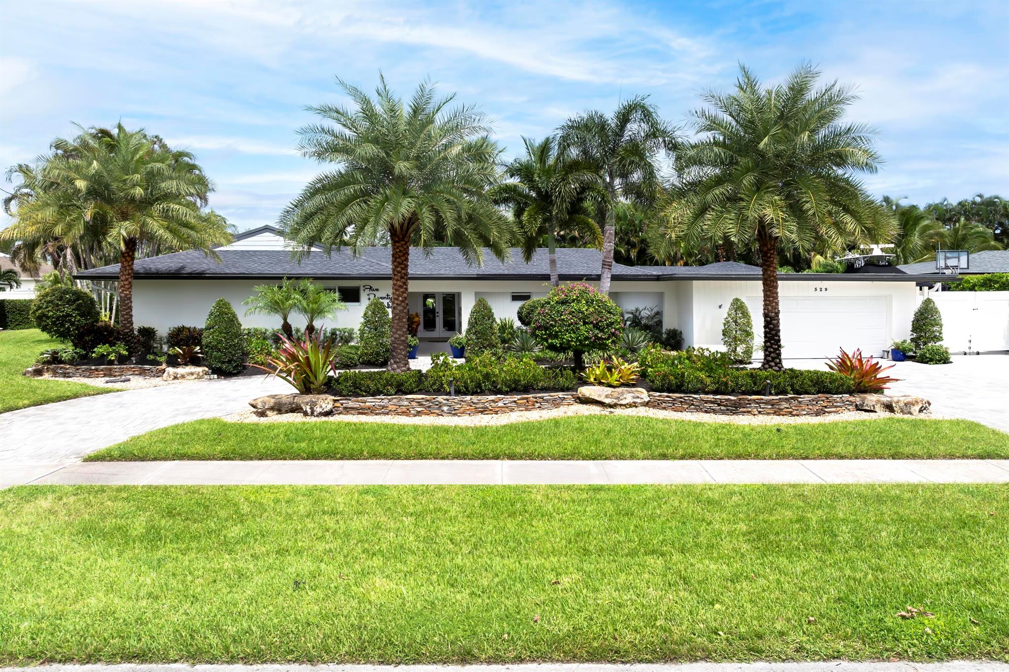 This stunning Mid-Century Modern Revival masterpiece was completely renovated in 2020 and offers an exquisite blend of style, comfort, and functionality. Boasting 4 bedrooms, a den/office, 2.5 baths, and an oversized 2-car garage, this home is designed for luxurious living. The CBS-constructed property spans 5,070 total sq. ft. (3,398 living sq. ft.) and sits on a beautifully landscaped .3464-acre lot with a resort-style backyard featuring a pool, sun deck, paver decking, a fully turfed bocce ball court, and a one-of-a-kind cabana with a summer kitchen, automatic retractable doors, and mini split A/C. The pool cabana is perfect for entertaining, with a one of a kind summer kitchen.