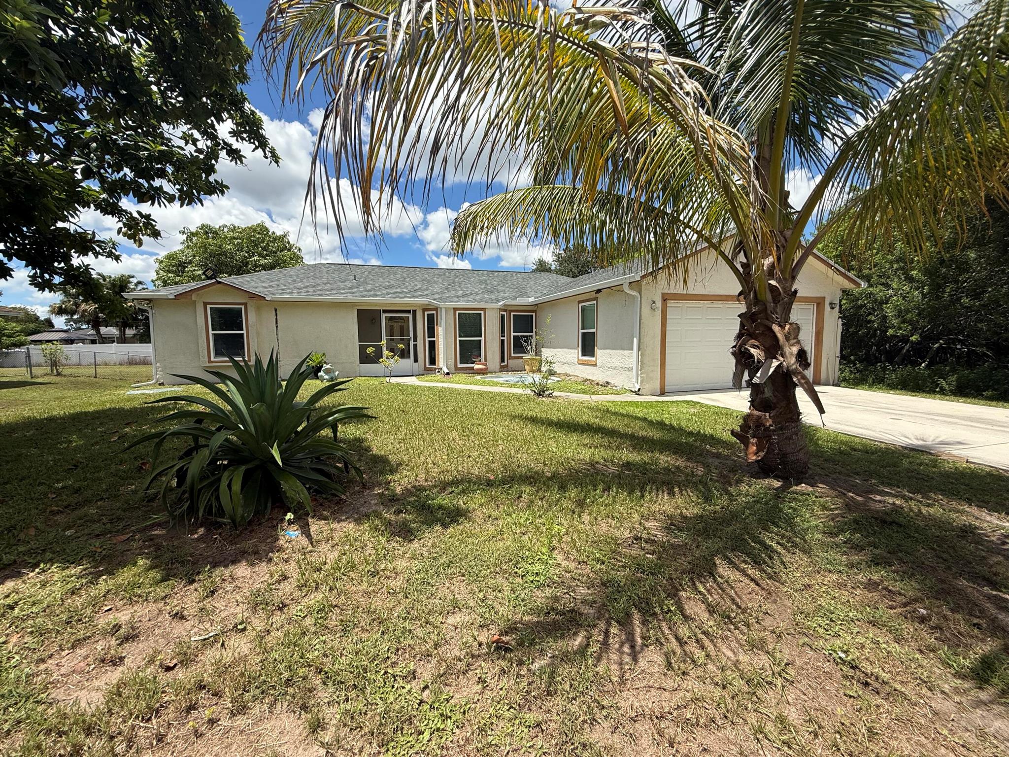 Newly remodeled 3 bedroom 2 bath home in the heart of Port Saint Lucie. Whole house has been tiled. NO CARPET. The house has been outfitted with NEW kitchen, NEW Impact windows, NEW roof, NEW washer and Dryer. The home sits on a large lot with a large backyard and covered patio. Great for any family looking for privacy and space.