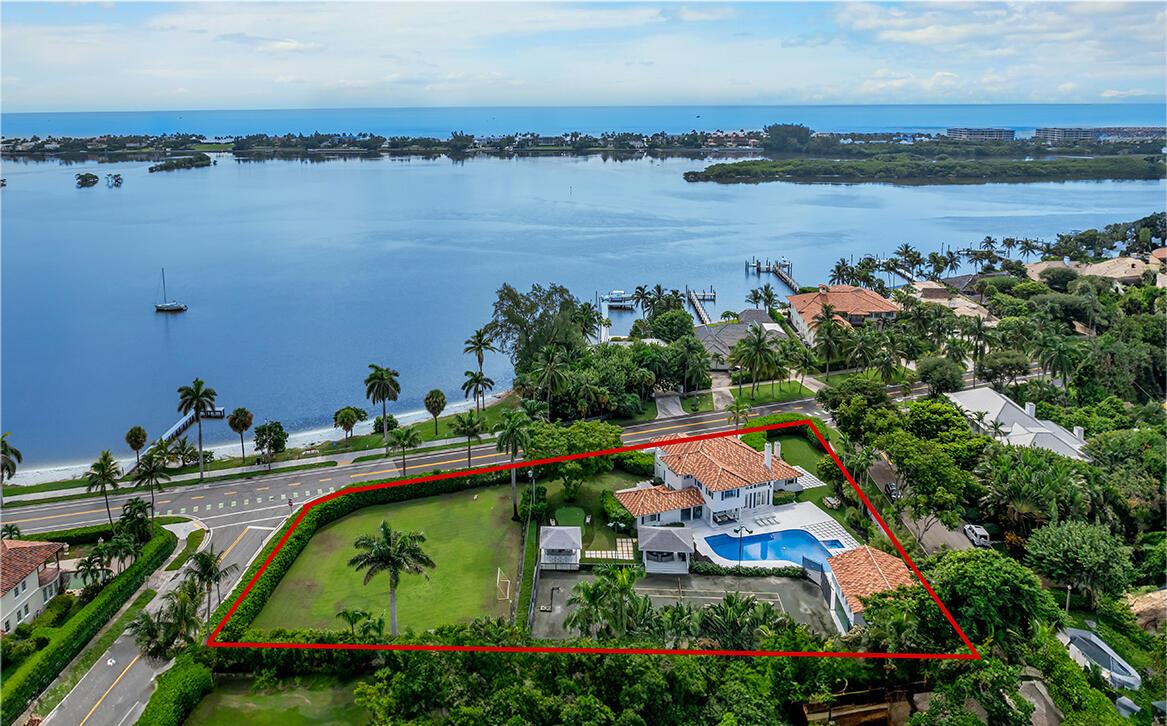 Exceptionally rare 282 feet of frontage on S. Flagler Dr. in SOSO- two parcels offered together. Properties span a block making this the largest available waterfront property in West Palm Beach. Over an Acre of land for a family compound with a newly renovated home, guesthouse with kitchen and water views, 40 ft long pool with spa, clay-lit tennis court with tiki hut seats 14 and outdoor marble bar seats 14, putting green and detached apartment for staff with kitchen. The North parcel has unobstructed water views across the wide intracoastal. Parcels are subdivideable into 3 lots.Six total bedrooms including a master on each floor with marble bathrooms with double sinks, large closets & large windows. Upstairs master with balcony and waterviews. Rare one of a kind family compound