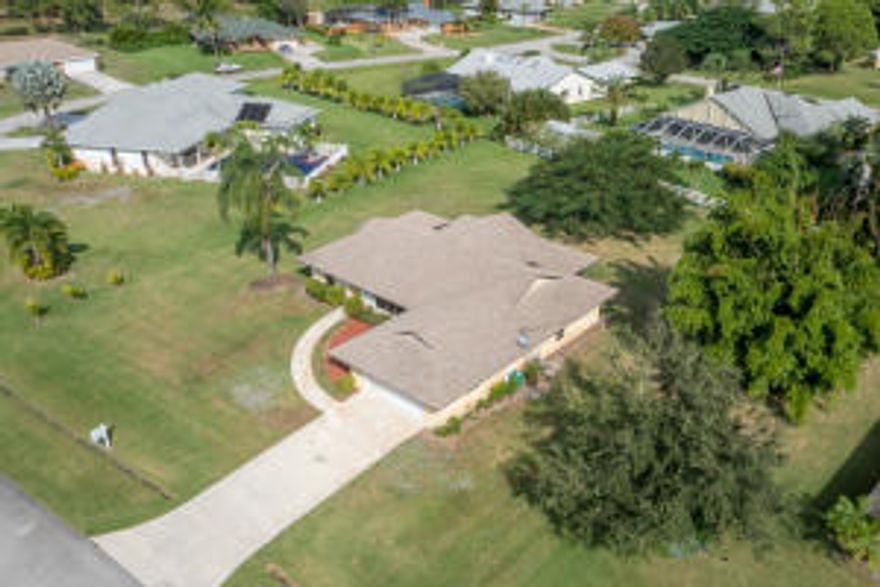 OVER 1/2 ACRE! This 3/2/2 is exactly what you are looking for. In move in condition, this home has brand new carpet, new paint, and BRAND NEW AC system! The large lot has plenty of space to roam! The master bedroom is incredibly big although it is a split plan from the other bedrooms. The main area of the home is large and open and great for entertaining from the kitchen as well as a generous sized patio which spans nearly the length of the home. Located in the Sandpiper area of Port Saint Lucie, this home is close to shopping of all kinds at the Treasure Coast mall as well as Downtown Jammin Jensen Beach! Want to go to the beach?! Jump in the car and head 15 minutes east and you will be at Jensen Public beaches or the Jensen Causeway for river Fun!