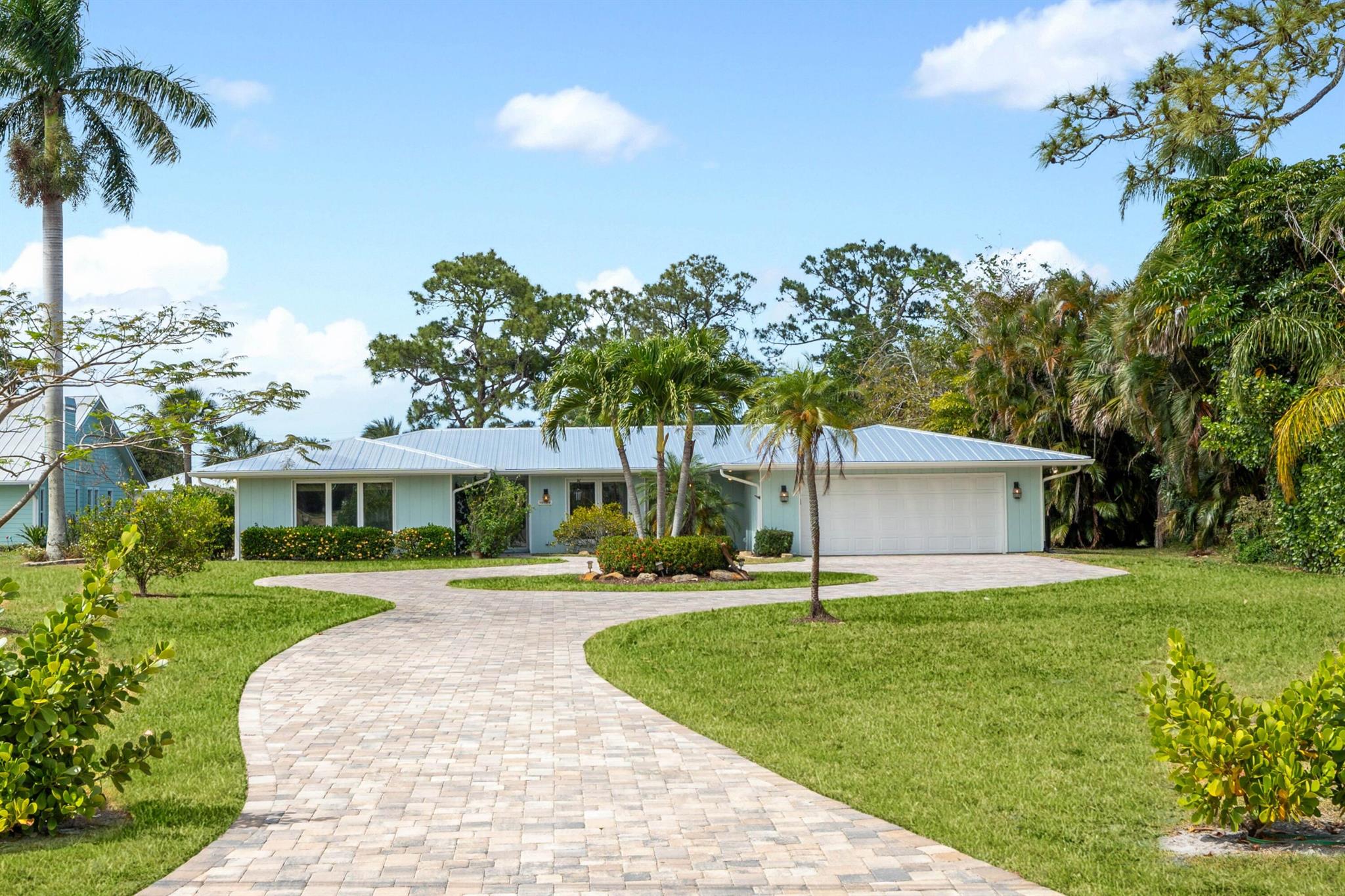 Experience the Florida lifestyle in the waterfront community of North River Shores! This CBS home is perfectly situated on over half an acre with 100 feet of water frontage, offering easy access to the river and beyond. Boating enthusiasts will love the brand-new 2021 dock with a 16,000 lb boat lift, while the sparkling oversized pool and expansive backyard create an entertainer's paradise. Inside, you'll find 4 spacious bedrooms with new wood flooring, 2.5 beautifully updated baths, and an impressive master suite. The heart of the home is a custom DREAM kitchen featuring Cafe Series appliances, Quartzite countertops from Spazio Stone, deep soft-close cabinetry, a coastal shaker design, and a breathtaking mother-of-pearl backsplash.