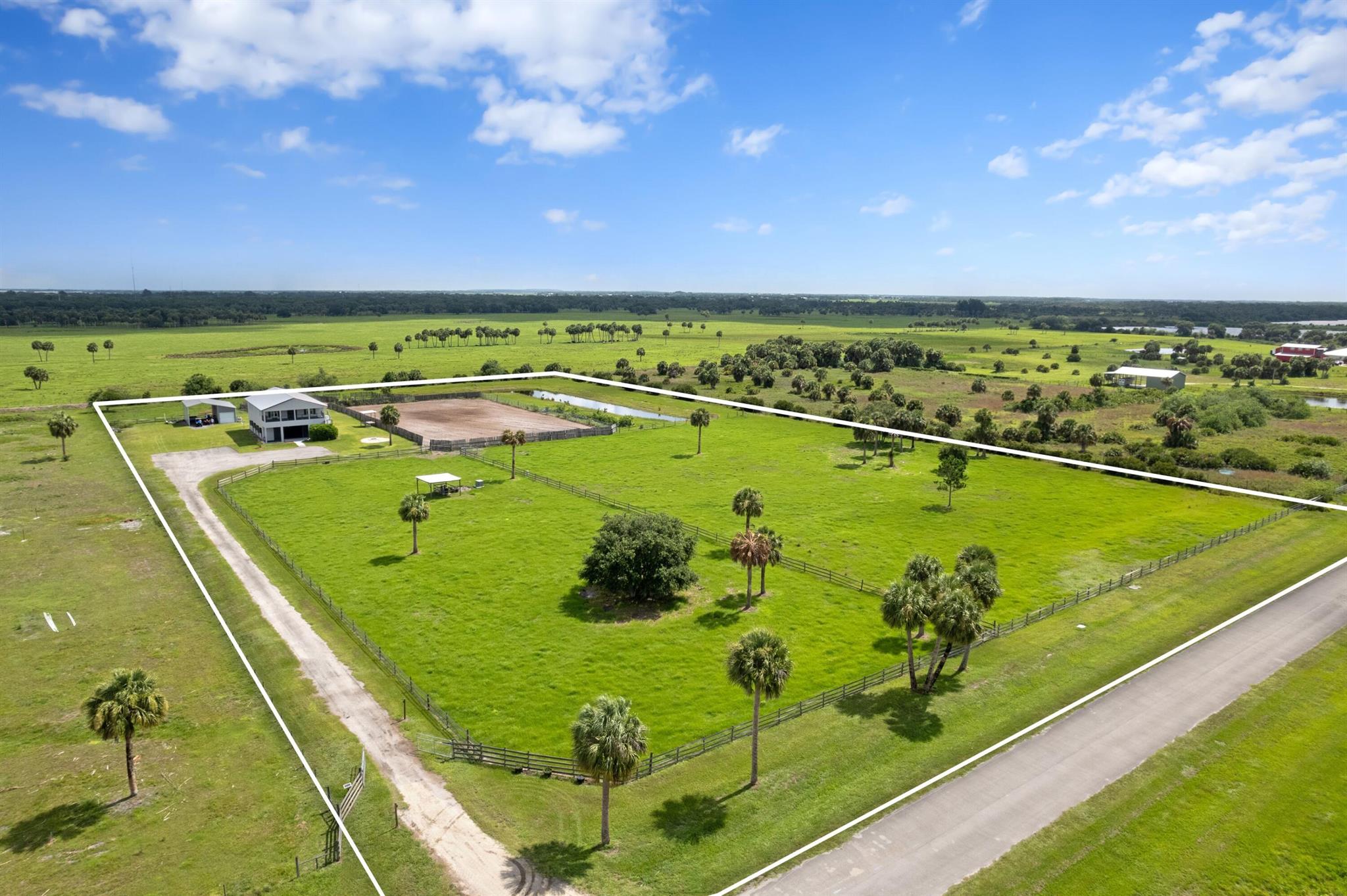 Stunning Equestrian Training Facility. Sherman Wood Ranches an Exclusive Gated Community. Situated on 8.65 acres of fully fenced pasture blends modern living with top-tier equestrian amenities. Custom built 8 stall barn offering air-conditioned tack room, feed room, auto fly spray system, horse wash bay and half bath. Riding amenities include a 140'x225' arena as well as a round pen. The house showcases modern farm house living with 3 bedrooms, 2.5 bathrooms. Endless picturesque sunset and sunrise views from nearly every room. 40x30 metal shop and garage. Sherman Wood Ranches is a gated community with easy access to Okeechobee Fair Grounds and Wellington International. An exceptional property perfectly suited for modern country living, horse boarding, or professional equestrian training