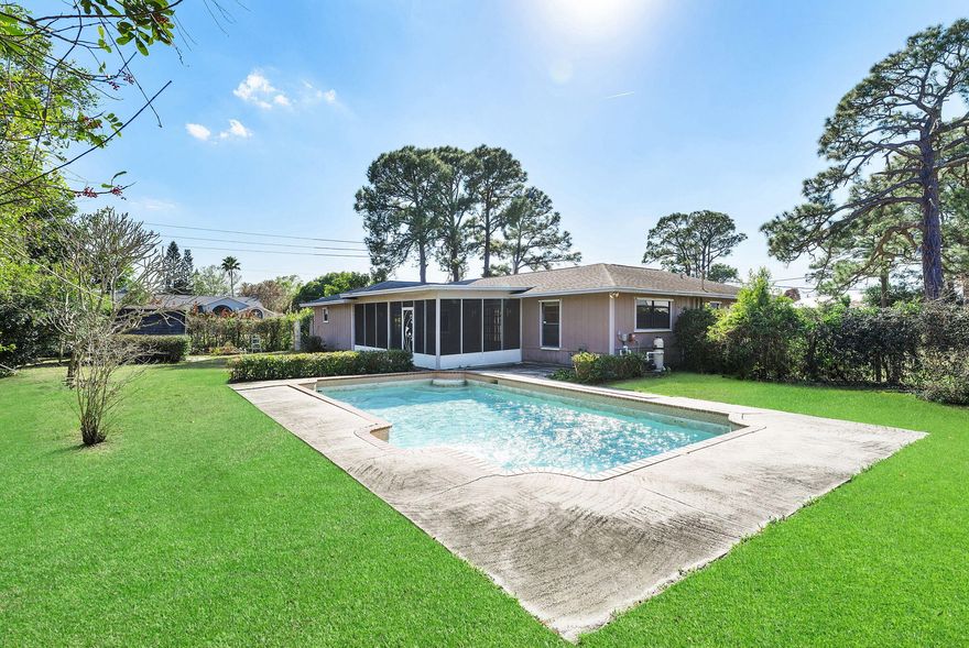 This 3-bedroom, 2-bathpool home sits on a premium oversized .40+ acre corner lot,  NO HOA, bring your boat, RV, and all your toys! A large circular driveway offers plenty of parking and curb appeal, surrounded by beautiful mature landscaping. Inside, enjoy volume ceilings, a split bedroom floor plan, and a large family room. Step outside to your screened and covered patio, ideal for dining under the stars, barbecuing with friends, or enjoying a refreshing swim in your tropical pool.  A/C (2016) and roof (2012), this home is ready for your personal touch and offers endless potential to make it your dream retreat.