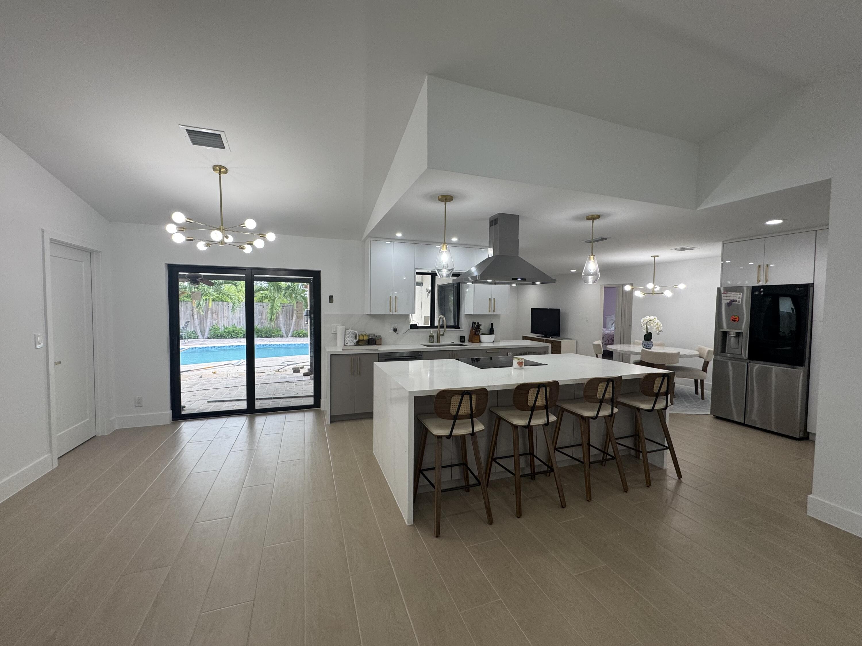 This is stunning, completely renovated home boats a central kitchen that opens up to both the family and living rooms, creating a spacious, open-concept layout that's perfect for entertaining. The large backyard features a beautiful pool, ideal for hosting guests or providing a safe, fun space for children to play. Additional upgrades include brand-new hurricane impact doors and windows, providing peace of mind and enhanced energy efficiency. This home combines modern design with practical features, making it a perfect blend of style and functionality. Plus, it's located in Highly desirable area with access to top rated, grade-A schools, making it an ideal choice for families. .
