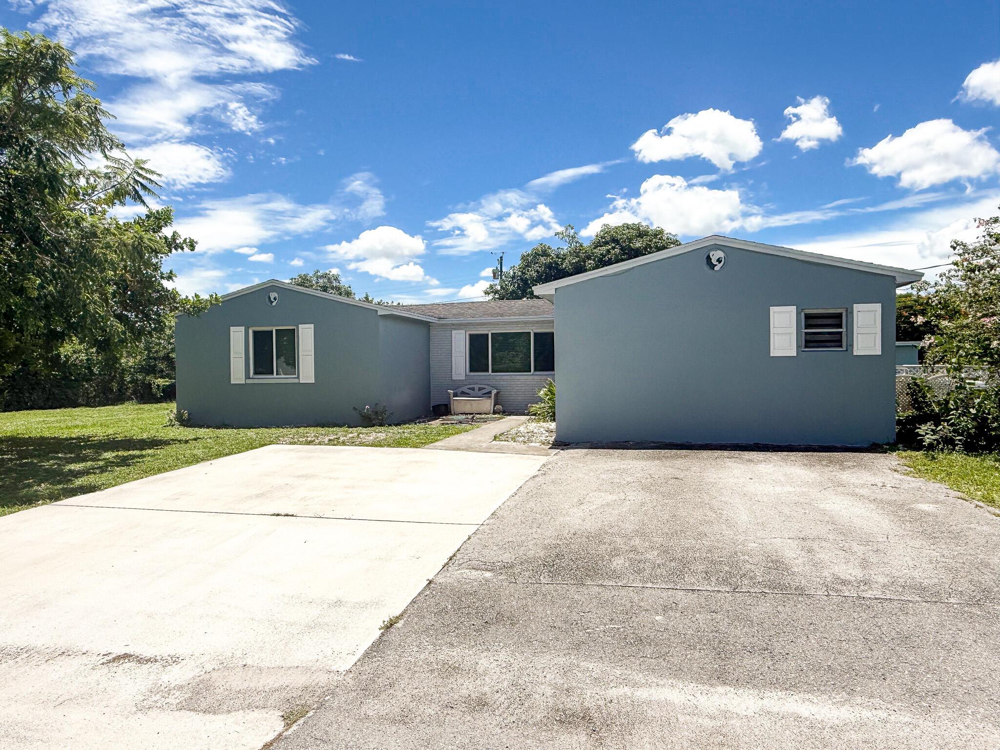Welcome to this 4-bedroom, 2-bath home nestled on just under half an acre in the heart of Palm Beach County with no HOA! Offering the perfect blend of comfort, space, and versatility, this property is ideal for families, multi-generational living, or those seeking a peaceful retreat. The home features a spacious primary suite or in-law suite, offering a private entrance and full bathroom--perfect for extended family, guests, or a secluded primary retreat. Enjoy an open and inviting main living area centered around a cozy wood-burning fireplace as well as generously sized bedrooms. The recently updated kitchen features ample cabinet space, upgraded countertops, and Whirlpool oven/range and microwave. Step outside to a large backyard with mature fruit trees and designated RV/boat parking,