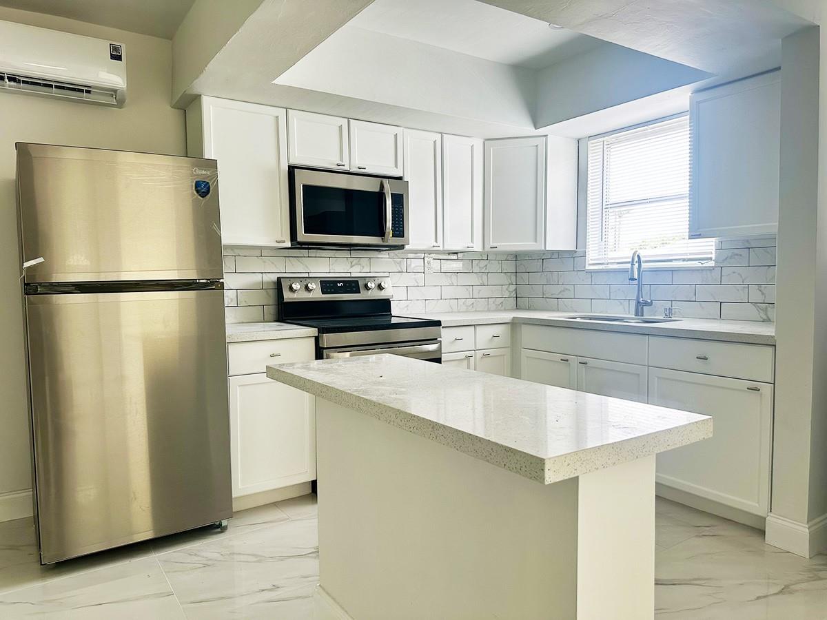 Discover modern living in this beautifully remodeled 1-bedroom, 1-bathroom unit, ideally situated in a well-maintained triplex east of I-95. This home has been thoughtfully upgraded with brand-new flooring, fresh paint, and stylishly renovated bathrooms, offering a sleek and contemporary feel. Enjoy the convenience of new stainless steel appliances and the luxury of in-unit full-size laundry, making daily life effortless. The open layout flows seamlessly into a spacious outdoor patio and an oversized side yard, perfect for relaxing or entertaining. Nestled in a prime location with easy access to Fort Lauderdale’s top destinations, including vibrant dining, shopping, and the beautiful beaches, this property offers both convenience and comfort.