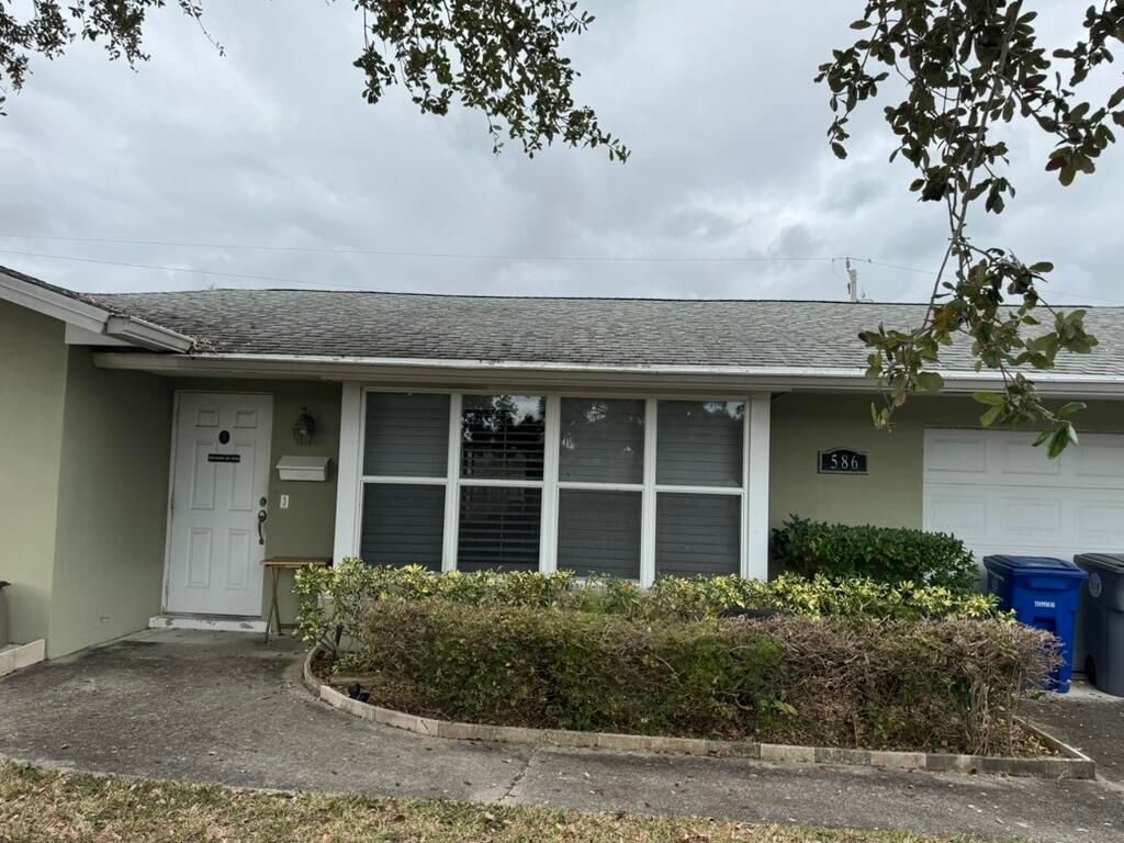 Photo of 586 N Redwood Drive, Lake Park, FL 33403 (MLS # B26027402)