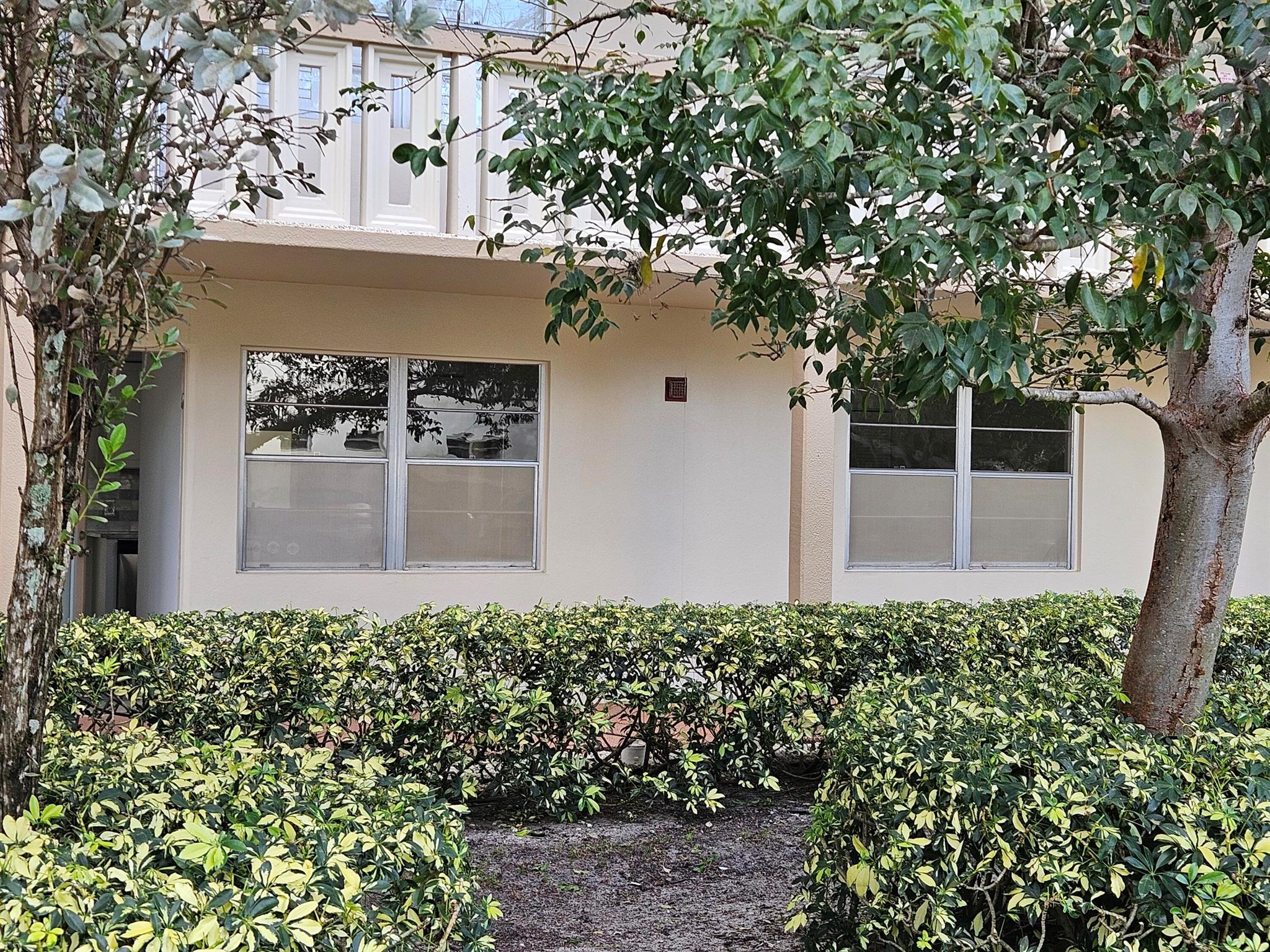 Totally redone, down to the studs; new vinyl luxury flooring throughout; neutral paint; new stainless steel appliances; granite counter tops and bath vanities; upgraded a/c; LED lighting & ceiling fans throughout. First floor unit convenient to neighborhood pool; community access gate within one block; view of golf course and lake from screen enclosed patio; roll-up hurrican shutters included. Parking space at the door and washer/dryer facility within 20 feet as is secure bulk storage lockers. Building recently re-roofed and painted. Adequate financial reserves with no extra assessments. Recent structural review completed. Wynmoor has country club style amenities including theater playhouse, large clubhouse with cafe', pool and fitness ctr. with hobby rooms. Close to turnpike,I-95 & beach