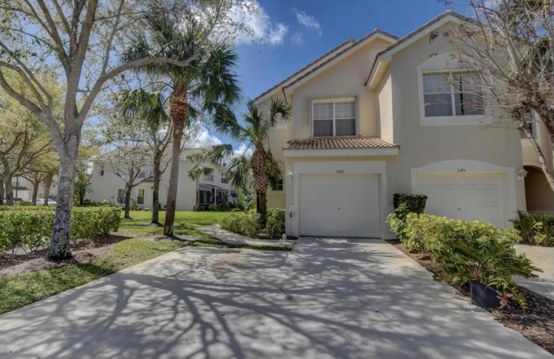 Gorgeous & Upgraded Lakefront/end unit with a 1 car garage conveniently located in the heart of Greenacres. Unit features laminate floors upstairs and on stairs, Porcelain Tiles downstairs. Upgraded Kitchen with quartz countertop, 2 car driveway and additional guest parking next to unit, large sliders look out at open patio with lake and preserve views, Don't miss out!
