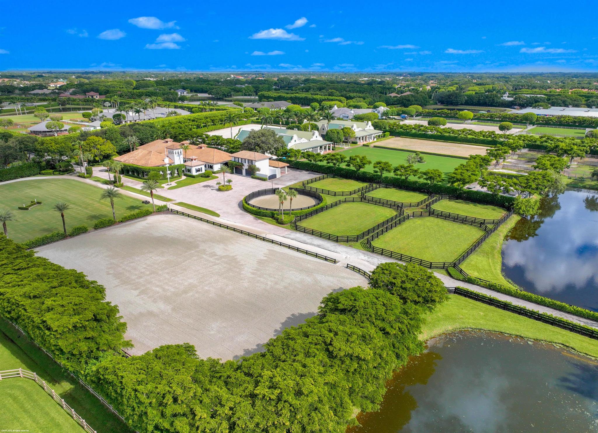 Nestled in the prestigious Grand Prix Village, this exceptional 5.88-acre equestrian facility offers unparalleled access to the horse show grounds via a private gate. Featuring 16 spacious stalls, a tack room, feed room, and four wash stalls, the property is designed for elite equestrian performance. The owner's quarters include a luxurious two-bedroom apartment, a private office, and a grand lounge for relaxation. Staff accommodations provide a comfortable three-bedroom, two-bath residence. The state-of-the-art all-weather arena, adjacent Grand Prix field, and track, complemented by five paddocks and a lunging ring, create a world-class environment for training and competition, making this facility a rare gem in the heart of equestrian excellence