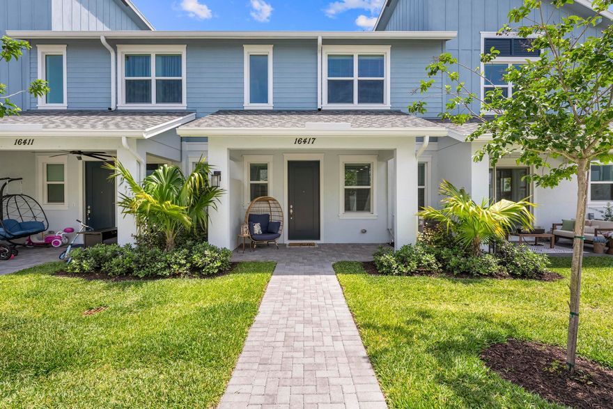 Welcome to this stunning newer construction 3-bedroom, 2.5-bathroom townhouse offering modern design, quality finishes, and functional living throughout. This beautifully built home features an attached 2-car garage with a hurricane impact garage door and an impressive 8-foot entry door.  Inside, enjoy soaring high ceilings, recessed high-hat lighting, and tile flooring throughout the main living areas. The open-concept kitchen is designed for both style and convenience with granite countertops, stainless steel appliances, and ample cabinet space. A convenient half bath is located downstairs for guests. Wood stairs lead to the second floor, where you'll find high ceilings and elegant wood-look tile flooring throughout. The spacious primary suite features dual sinks, a walk-in closet, and a large walk-in shower. The upstairs laundry room includes built-in cabinets for additional storage and convenience.  All appliances are 2025 models. Relax on the covered front porch and enjoy additional guest parking located directly on the street. This move-in ready new build offers the perfect combination of modern upgrades, comfort, and low-maintenance living.