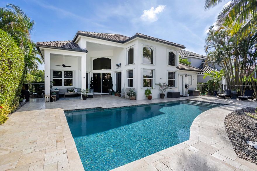 Step into timeless sophistication in this fully updated 4-bedroom + bonus room lakefront pool home in the prestigious gated community of Boca Falls. Tucked on a serene lot with no front neighbors, this residence blends luxury, comfort, and privacy. Inside, enjoy soaring ceilings, ceramic tile flooring throughout the main floor, and real wood floors upstairs. The bonus room includes a closet and offers versatility as a home office, guest suite, gym, or playroom. The chef's kitchen boasts quartzite countertops, premium appliances, and custom cabinetry. The primary suite features a spa-inspired bath and custom closets, while all bathrooms showcase upscale finishes and rainfall shower systems. Outdoors, relax or entertain by the resort-style PebbleTec pool and travertine patio. Additional highlights include electric blinds, a new roof and 2 A/C units, and a 3-car garage with upgraded flooring. Boca Falls offers A-rated schools and top-tier amenities: gym, tennis, pickleball, basketball courts, a playground and security. This is one of the most updated homes in the community.