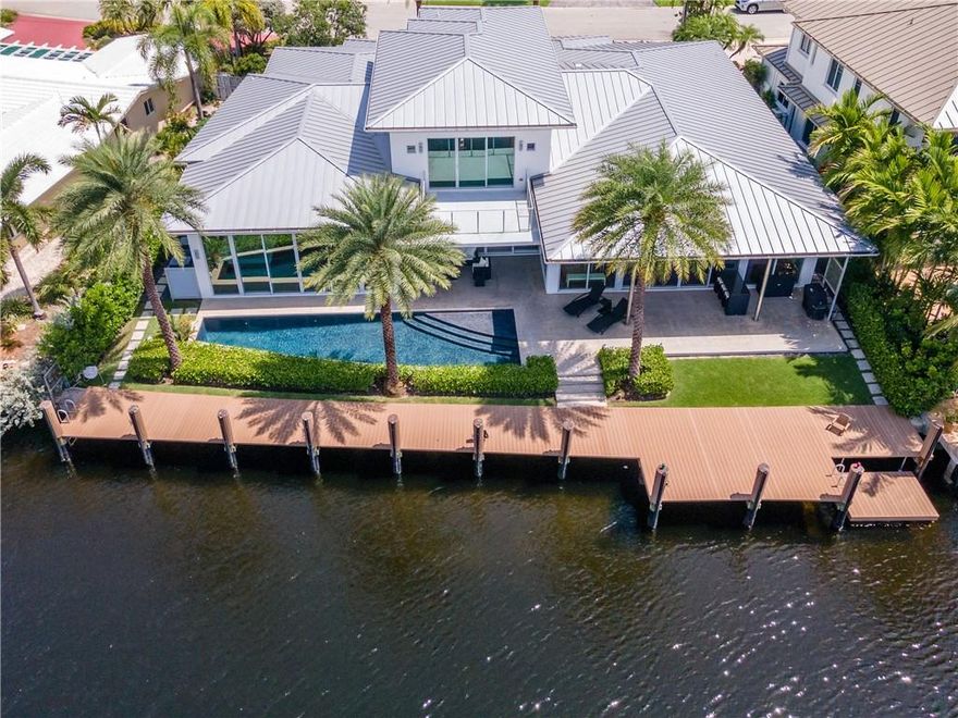 Discover a beautifully sleek single story home in the heart of The Landings Ft Lauderdale, where modern design meets green-home features. It is adorned with energy efficient low-E hurricane-proof windows, 10 to 20 ft ceilings, aluminum roof, Miele appliances, a heated chlorine-free pool, 3 car garage, a 102-ft deep-water dock for your boat - that's right, no fixed bridges and a much wider canal. In the attic Icynene spray foam insulation and 18-seer high efficiency a/c units.The adjacent view of the canal can be seen by almost anywhere on the first floor and loft. The architect, Robert Tuthill, made it his mission to create a space where energy efficient features would work seamlessly with contemporary design. Located off of Bayview and conveniently close (1.4 mi) to Lauderdale By the Sea.