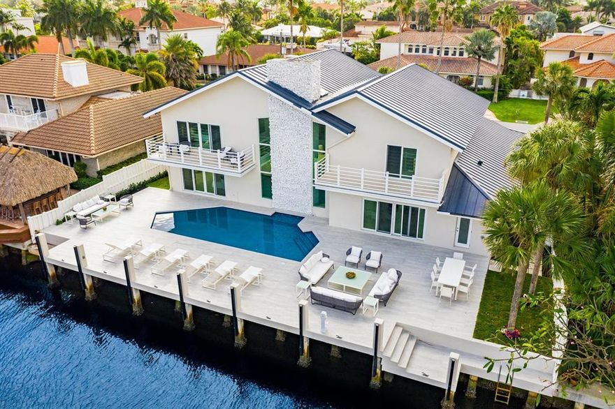 This spectacular newly reconstructed contemporary home is located in the prestigious waterfront community of Tropic Isle of Delray Beach. It is approximately 5000 square feet under air with four bedrooms and four full baths. The home features 90 feet of deep water on a wide canal. This exclusive home embodies modern finishes including a custom kitchen with a Sub Zero refrigerator, a Viking double oven and Thermador induction cooktop, quartz countertops with island seating for eight, an open floor plan with cathedral ceilings, marble and porcelain floors, impact windows and doors throughout, an oversized loft, and a gorgeous outdoor patio with plenty of room for entertaining.  This waterfront home is located a few houses off the intracoastal where there are no fixed bridges for boating.