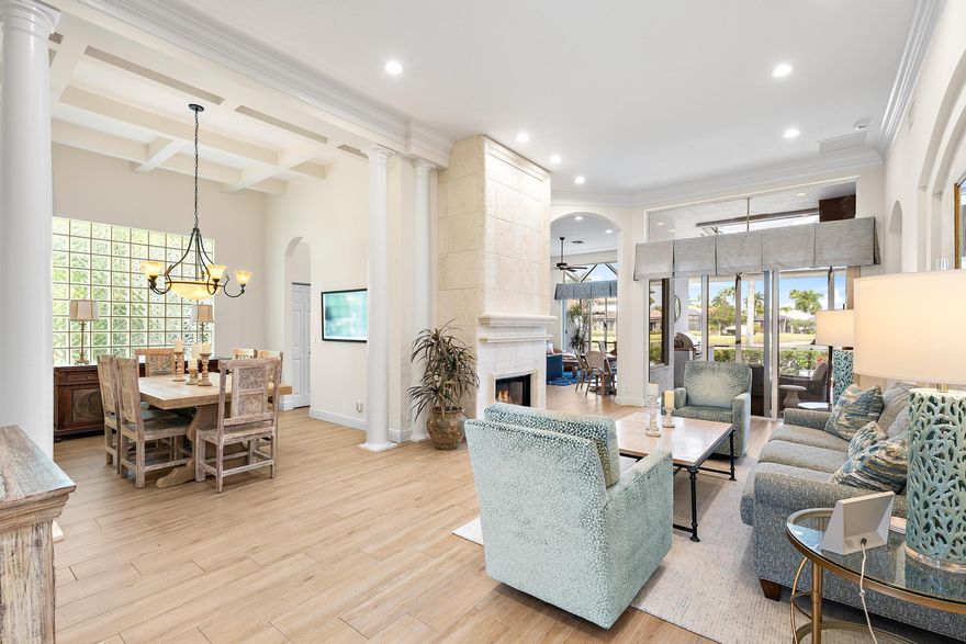 This stunning and elegant former builder's model, one-story lakefront residence has been extensively upgraded and thoughtfully enhanced, offering timeless architectural detail paired with meaningful, high-value improvements. Major infrastructure updates include a 2018 roof with transferable warranty, a 2022 AC system with 10-year warranty, and a comprehensive 2024 HVAC redesign creating a true two-zone system with dedicated climate control and private thermostat for the primary suite. Soaring ceilings layered with crown molding, stately columns, built-in mirrors, box-beam detailing, and custom millwork reflect the elevated craftsmanship of a former model home. Wood-look porcelain tile flooring installed in 2017 enhances the main living areas, while 2024-2025 interior improvements include new kitchen and bathroom countertops, new sinks and faucets throughout, factory-refinished kitchen cabinetry, new LED ceiling lighting, a new powder room vanity with updated fixtures and designer wallpaper, and a new over-the-range oven/microwave/air fryer combination creating a true two-oven kitchen. Three bedrooms received new carpeting in 2023, and much of the interior was repainted in 2023, followed by a full exterior repaint in 2024.
The cast stone gas fireplace anchors the living room, and expansive sliders open to the screened lanai where a heated pool with waterfall overlooks wide lake views and a beautifully illuminated fountain. In 2025, a new compressor and fan were installed for the primary bedroom AC. Additional significant upgrades include a 2023 pool heater, 2025 gas fireplace insert with remote control, 2025 outdoor gas grill, and ongoing mechanical refinements that ensure comfort and reliability. Sliding doors, screens, and lanai components were serviced in 2024.
Located in The Grande, the only single-family enclave in Ibis offering residents exclusive use of its own private community pool, this residence also provides access to the Club's 90,000-square-foot clubhouse, three Nicklaus-family championship golf courses, dining, fitness, spa, and premier racquet facilities.

IBIS MEMBERSHIP FEES ARE INCREASING. BUYERS WHO GO UNDER CONTRACT BY APRIL 1, 2026 AND CLOSE BY JUNE 12, 2026 CAN SAVE A MINIMUM OF $30,000.