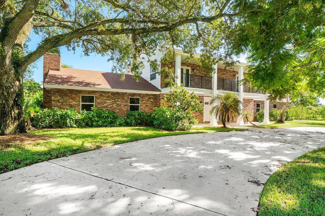 This stunning 8-bedroom, 6.5-bathroom residence features a fully remodeled main home and a private guest house, all set on almost 2 acres of newly landscaped grounds with a screened-in pool and backyard pond with a brand-new dock.The main home offers 5 bedrooms and 4.5 bathrooms, highlighted by a first-floor primary suite, a spacious great room overlooking the pool, a formal dining room, den, and two-car garage. Upstairs includes a second primary suite and three additional bedrooms with a shared double vanity bath. Upgrades include fresh paint, new flooring, custom woodworking, impact windows and doors, and a fully renovated kitchen with white shaker cabinets, quartzite countertops, and new stainless steel appliances.