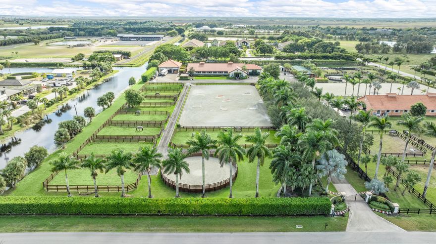 🌟 A rare equestrian jewel in Wellington's most coveted location! Positioned minutes from the new South entrance to WEF and Parcel F, where the show expansion is redefining the equestrian experience, this 5-acre estate offers unparalleled prestige and performance.
Step inside a world-class facility boasting 23 custom stalls, 9 manicured paddocks, a professional round pen, and a spectacular 136' x 270' riding arena completed in 2023. Designed for both elegance and efficiency, the property also features 2+ bedroom staff quarters, RV accommodations, dual tack rooms, dual laundry centers, and a dedicated storage building for hay, grain, trunks, and more.
✨ The grand canopy entrance sets the tone—an architectural statement that is truly one-of-a-kind in Wellington. A Must See Pr