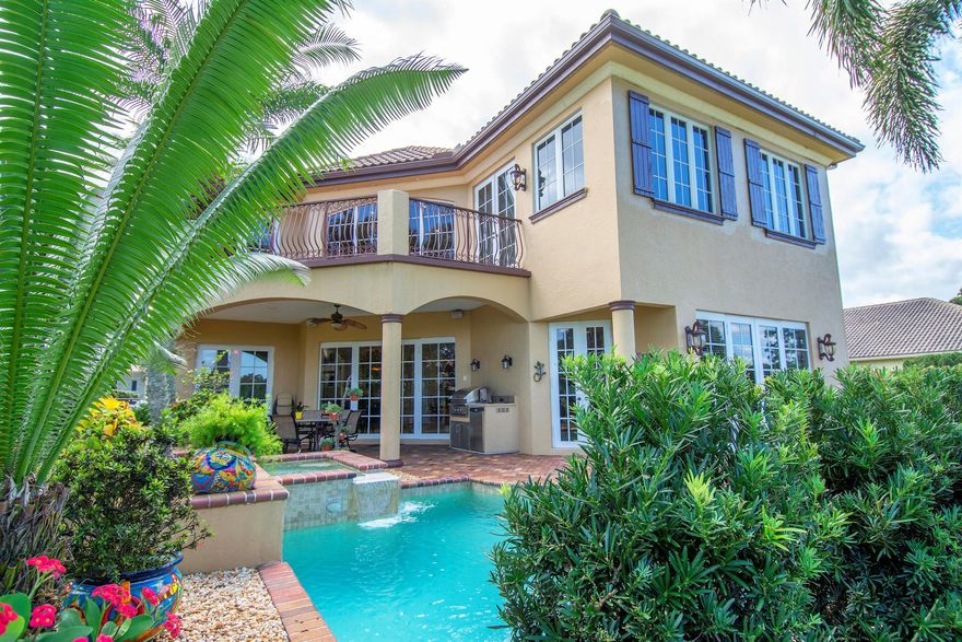 This custom-designed Spanish Revival home awaits you, featuring an arched entryway with columns designed to catch the breezes & the eye. The home features 24-foot high ceiling with a wall of storm-proof windows in the Living room. The great room, dining, living, office, & owner's suite are all on the first floor. The owner's suite has access to the pool & features double closets with custom shelving. The junior owner's suite, loft, & bedroom suites 3 & 4 are on the second floor, with a large balcony overlooking the pool & the Palmer 5th Green. The office has hardwood floors with views of a private garden. The covered back porch with an artisan-designed pool/spa creates a fantastic space to entertain guests. Tesoro is a gated golf community. Membership is not required.
