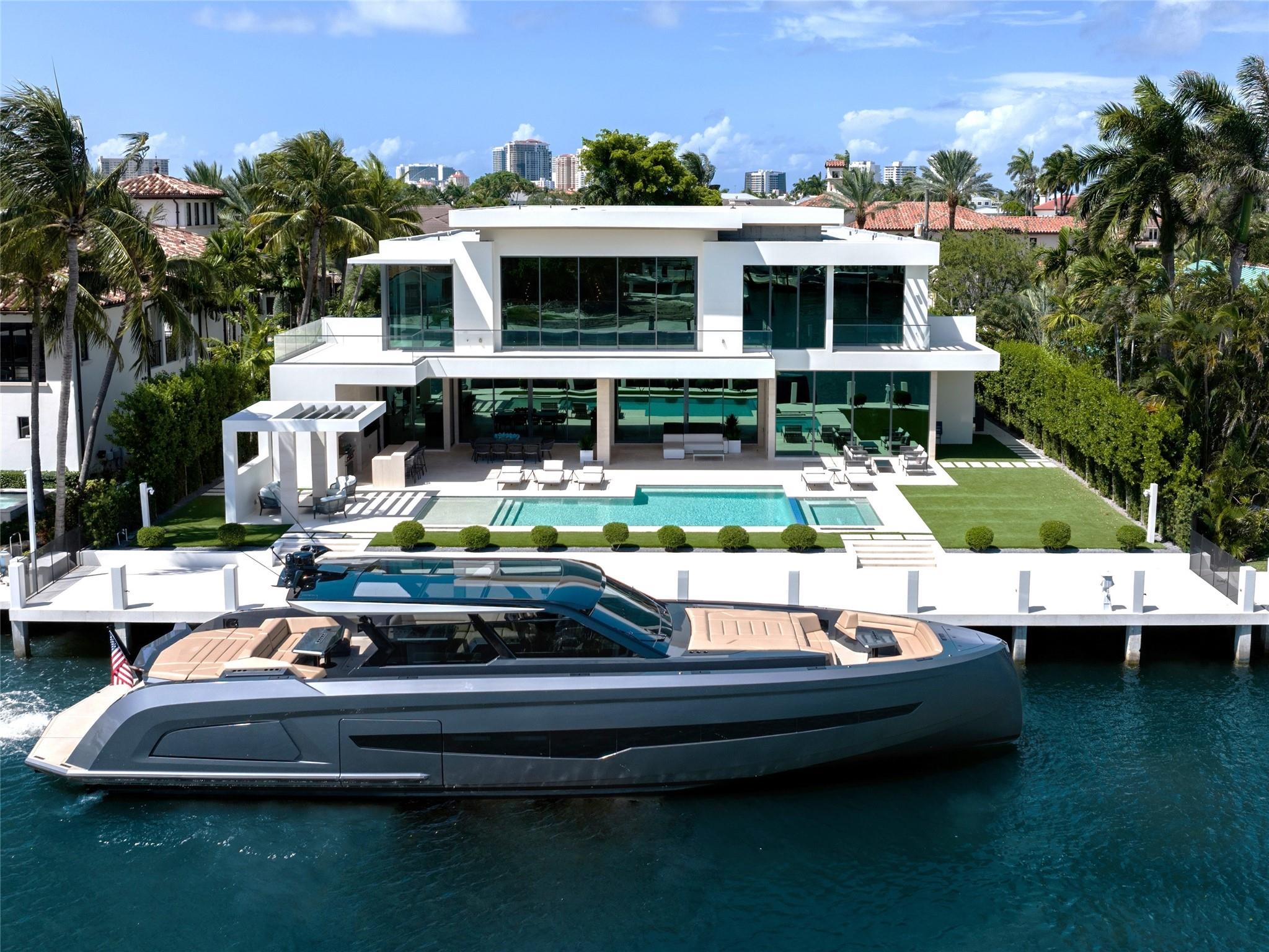 One of the newest Estates to be completed in guard-house gated & private Surf Club, Harbor Beach ! 110 ft deep-water dockage, open panoramic views on wide turning basin & premier Del Lago address. Stunning Coastal Modern collaboration by Randall Stofft/Sarkela Corp/professional interior design & furnished by Italian D-Editors. Built to highest custom standards with extraordinary detailing & materials throughout. Floorplan focus on open concept living, Chef's kitchen & separate prep/caterers kitchen, expansive club/media room, elegant formal dining area & first level VIP suite. Ultra-luxurious primary suite with dual spa-style baths & separate completed custom closets. Spacious bedrooms & second VIP suite, incredible views from many rooms, private resort style pool. Lift compatible garages.