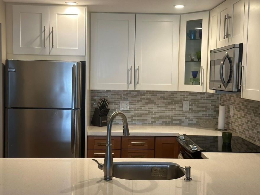 Completely renovated large one bed, one bath just East of US 1 in East Point Towers. Over 896 sq ft under air boasting a renovated kitchen with quarts counter tops, custom cabinetry, tile backsplash, stainless steel appliances, opened kitchen overlooking the living/dining area, impact windows and doors, wood look tile floors, updated bathroom, California Closets in primary closet.  Living Room overlooks the common courtyard with lush landscaping and from the private balcony, you can see the pool and Middle River. Lobby area and hallways were recently renovated.  East Point offers a new heated pool on the water, dockage for a boat, fitness center, and club room. Walk to the beach and Galleria.  Great value for this location and one of the lowest priced condo’s at the community.