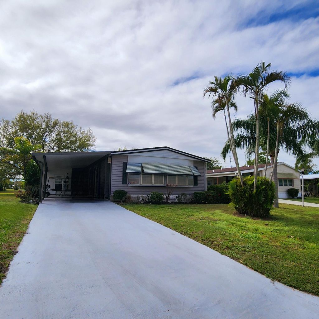 Photo of 105 E Carribbean, Port Saint Lucie, FL 34952 (MLS # R11066988)