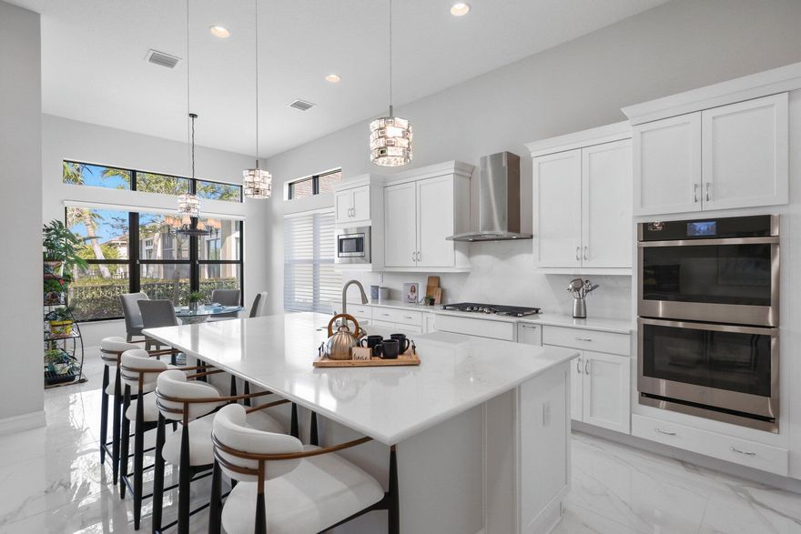 Welcome to 9149 Leon Circle East in Four Seasons at Parkland, where modern elegance meets serene waterfront living. This beautifully designed home offers 2 bedrooms, an Office / Den, 3 bathrooms, and 2,607 square feet of open-concept living space. Enjoy stunning long-range water views, complemented by sleek 36-inch white and gray marble-look porcelain flooring throughout. The light-filled breakfast area and gourmet kitchen create the perfect setting for both everyday living and entertaining. Situated on a private end lot with lush green space, the screened-in lanai provides a peaceful retreat overlooking the water and charming fountain. Located on a 6,124-square-foot lot, this home offers the ideal blend of comfort, style, and privacy.