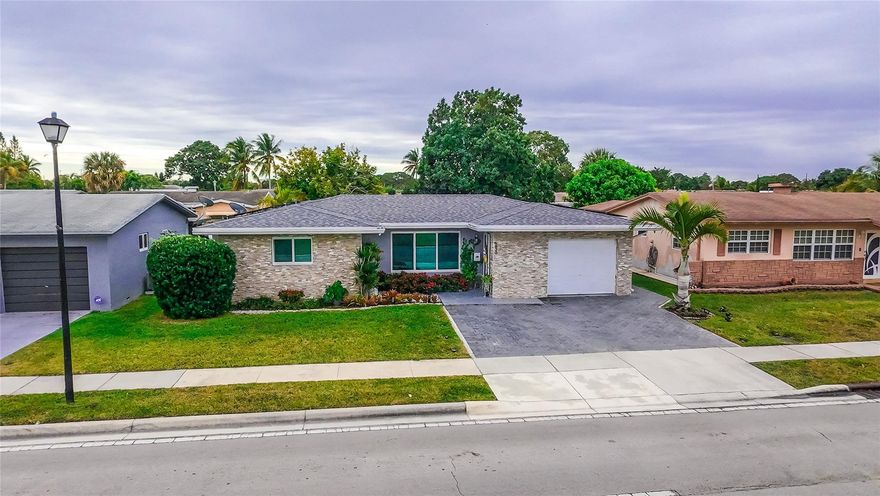 Immaculate and beautifully maintained residence located in the desirable Paradise Gardens 55+ community. This home features hurricane impact windows and front entry door, a new roof (2025), and a new electrical panel. Truly move-in ready, offering a low HOA fee of $286 quarterly. Only one resident is required to be 55 years of age or older. The primary suite boasts a spacious walk-in closet, the kitchen is generously sized, and the remodeled driveway provides ample parking. The property also includes a one-car garage with an automatic door and access to the community pool.Spacious living area with a large window that fills both the living and dining rooms with natural light.