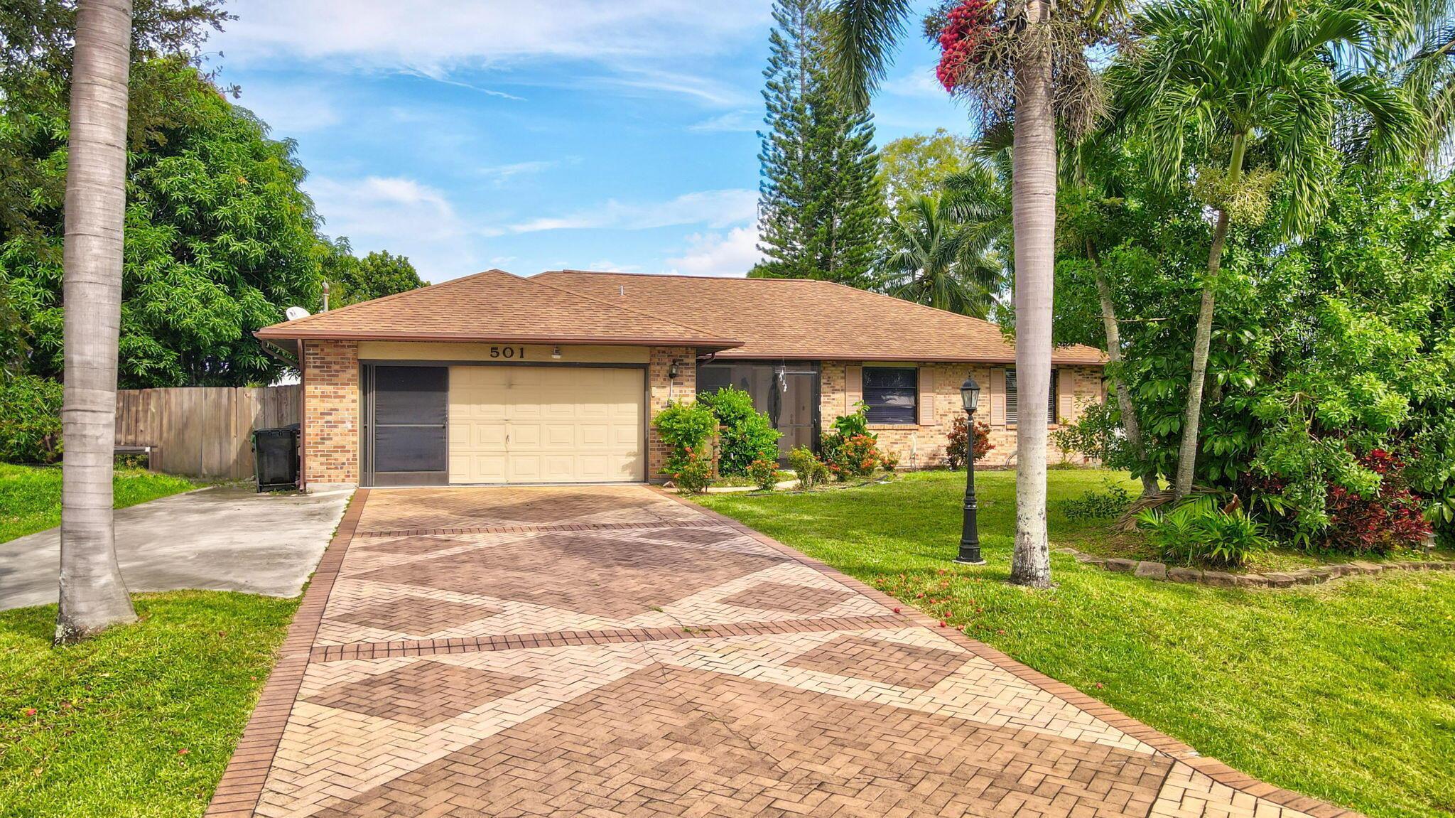 You'll fall in love with this charming fenced corner home! It features an oversized driveway plus a lovely mango and avocado trees, perfect for enjoying the outdoors. Inside, you'll find 3 bedrooms and 2 bathrooms, along with a spacious living room and a massive eat-in kitchen complete with a center island. The dining room is perfect for gatherings, and the expansive 13 x 48-foot screened-in patio--equipped with a hot tub--offers an ideal space for entertaining. The 2-car garage provides extra storage, and there's a large shed in the backyard waiting to be filled. Additionally, you'll enjoy the convenience of supermarkets, commercial plazas, and highways just a 5-minute drive away. This home has it all!