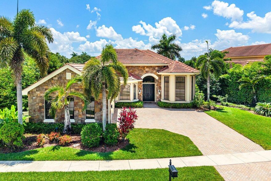 Nestled on a breathtaking 1/3-acre lakefront lot with serene fountain views, this rare single-story pool home in the highly sought-after community of Versailles in Wellington offers the perfect blend of luxury, comfort, and tranquility. Thoughtfully updated and impeccably maintained, this pristine residence features partial impact windows, newer appliances, a gas tankless water heater, and a screened-in patio designed for seamless indoor-outdoor living.  The fully renovated primary bathroom is the epitome of luxury, creating a spa-like retreat within your own home. Additional upgrades include new luxury vinyl flooring in two bedrooms, custom closets, and countless thoughtful enhancements throughout. Whether relaxing by the pool, enjoying peaceful water views, or entertaining guests, every detail of this home has been curated to inspire comfort and serenity.  Opportunities like this are rare — a beautifully updated one-story lakefront home with unmatched views and timeless appeal in one of Wellington's premier gated communities. This exceptional property is truly not to be missed.