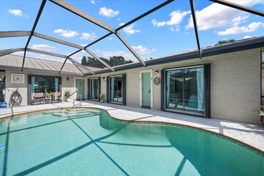 Experience Florida living at its finest in this stunning single-story corner unit townhome in the highly desirable community of Westwood Gardens. Enjoy gorgeous lake views, breathtaking sunsets, and the comfort of private pool living with a screened-in patio-perfect for relaxing and entertaining all year round. This 3-bedroom, 2-bath home offers a spacious split floor plan with vaulted ceilings and all-new flooring throughout, creating an open, airy feel. Each bedroom features sliding glass doors that open directly to the pool area, seamlessly blending indoor and outdoor living. The updated kitchen includes modern finishes and an under sink reverse osmosis system, complemented by a full-house water filtration system for added convenience. Some updates include a metal roof,