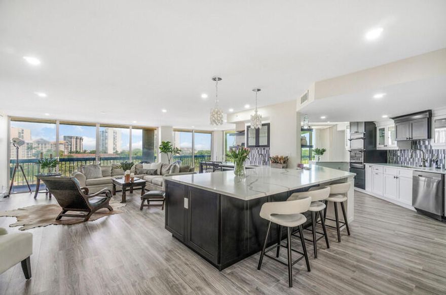 This impeccably renovated 3 BR, 2 Bath home blends modern elegance with effortless living. The open-concept design showcases a beautiful chef's kitchen, with wall oven and great appliances and island with  quartz countertops, ideal for entertaining, while the expansive wrap-around terrace creates a seamless outdoor-indoor lifestyle. Every room has floor to ceiling window/doors that allow to enjoy great views. Set with-in a full-service deluxe building that has completed all legally required upgrades, this residence offers sophistication, security and turnkey convenience. As soon as you enter the building you feel luxury with a beautiful  renovated lobby, white glove full service with 24/7 concierge, daily Valet Golf cart 5 to 11 PM , full time manager on site, maintenance  cleaning crew Furthermore the condo has a brand new AC and the terrace was just redone. Also the electric is new with special lighting throughout the unit. The walls and ceilings are smooth and the floor is a convenient and easy to maintain vinyl with wooden look throughout. The location is prime on Dutchman's Pipe Golf and the Belgrove Marriott Autograph resort next door as well as the Tanger Outlet Mall with Wholefoods, Saks of Fifth, Ralph Lauren and much more, stores and restaurants and only minutes from PBI Airport,  Palm Beach Island with its beaches, great restaurants and Worth Avenue with World class de luxe shops and galeries , and Downtown West Palm Beach with Kravis Center of Performing Arts, State of the Art Norton Museum,