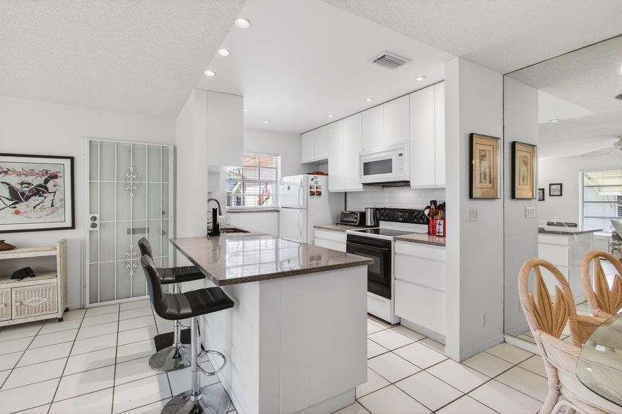 Pride of ownership shines through the moment you step into this highly sought-after, updated, and spacious 2BR/2BA corner villa, nestled in the vibrant High Point Community. This exceptional villa, located in the most desirable corner  Florida Model, offers the perfect blend of modern comfort and classic charm within an active 55+ community. Key features include: Roof replaced in 2019 for peace of mind. Enclosed Florida room under air, expanding your living space year-round.
Awning shutters for added protection and curb appeal. Open-concept kitchen with updated cabinetry, granite countertops, and modern appliances.
High-hat lighting, enhancing the home's bright, airy feel. Water heater replaced in 2018 and AC handler installed in December 2017 for efficiency and comfort. Tastefully updated guest bathroom for added luxury. Neutral tile flooring throughout, offering a fresh, contemporary look.

This villa comes fully furnished and turnkey, so all you need to do is bring your clothes and toothbrush to start living the Florida lifestyle.

Enjoy the very best of Florida living in this active 55+ community, offering a range of social activities and amenities that include a resort-style heated pool, a spacious clubhouse, tennis and pickleball courts, and shuffleboard. Conveniently located just minutes from the beach, you're close to charming shops, open-air cafés, fine dining, shopping malls, theaters, and more. Plus, with easy access to I-95/Turnpike and nearby places of worship, everything you need is right at your doorstep.

All information is deemed reliable but not guaranteed and is subject to change without notice.