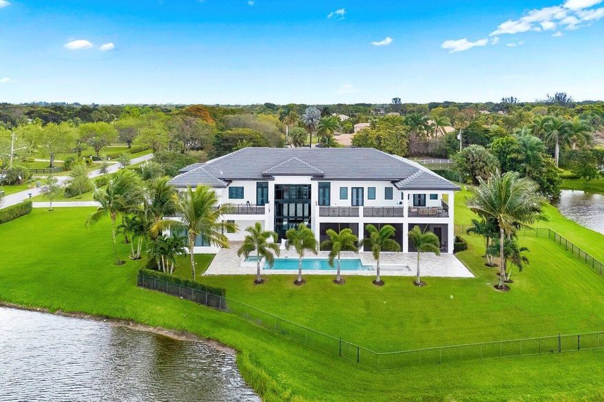 This true estate on 5.66 acres features dramatic lakefront views within the private gated community of only 78 homes.  As a transitionally modern designed residence, it features a two story main entry, foyer and main living room, with soaring floor to ceiling glass windows.  A billiard area, family/ media area, dual island full kitchen, bar area, a primary suite with dual bathrooms and secondary bedroom suite complete the first floor level interior. A 45 foot covered patio with winter kitchen, an open heated pool with spa complete the exterior.  The secondary level consists of four full bedroom suites, three of which open to spacious open and covered patios, and a media/ club room. A grand circular driveway, four car garage and lush landscaping offer total privacy.  See MORE ...