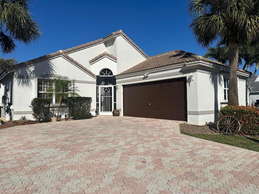 It's all about the VIEW with this spacious, sunny & serene 3-bedroom, 2-bathroom home with a desirable split-bedroom layout and 2-car garage in the beautiful gated community of Newport Cove. Home features 2 chargers for electric cars, solar panels for your LOW monthly electric bill, generator, updated kitchen & bathrooms, skylights, ample storage, & laundry room with full-size washer and dryer. Primary bath has his and her sinks, walk-in shower & roman tub. Furniture optional. Screened patio with long view of lake has fire pit & gas stovetop perfect for entertaining. This exceptional community offers a pool, tennis courts, basketball, gym, walking trails, pickleball, clubhouse, & fitness center. Conveniently located near schools, shopping, beach, parks, Atlantic Avenue, Turnpike & I-95.