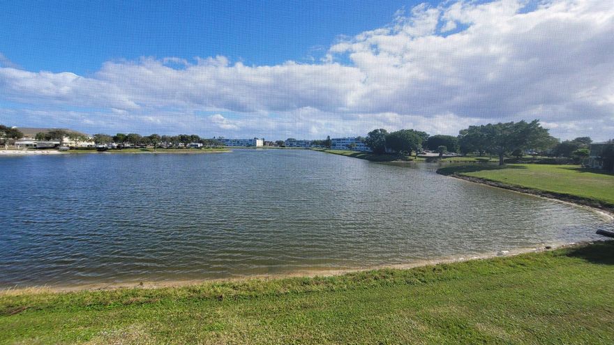 Beautiful expansive lake views from this 2-bedroom, 2 full baths condo on the second floor of a well-kept and well-funded association. Watch the sailboats, local wildlife, or fish from your backyard. Highly desirable Somerset section that features a lovely pool, tennis, and pickle ball courts. Both bedrooms have gorgeous water views and have access to the screened lanai. The kitchen features newer appliances and granite countertop, tile backsplash, and recently installed Maytag dishwasher. Century Village Is a resort style, 55+ community with so much to offer... you will be proud to call this home.