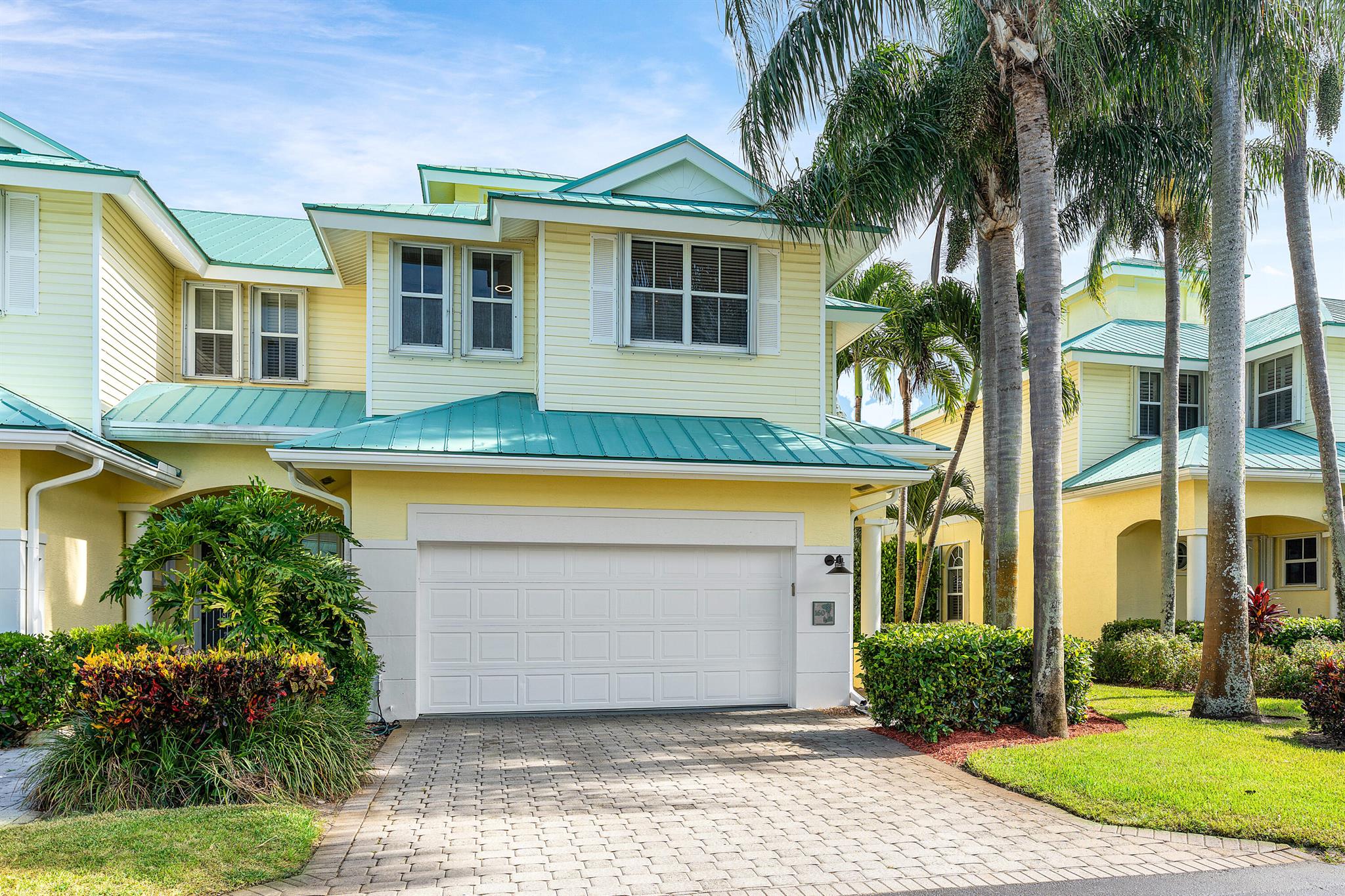 Welcome to Barefoot Cove, a tropical paradise gated waterfront community where every day feels like a vacation. This beautifully updated 3-bedroom + den, 3-bathroom end unit townhome offers the perfect blend of privacy, comfort, and coastal charm. Located directly across from the Intracoastal-front pool, this residence is one of the most desirable spots in the neighborhood.Step inside to discover thoughtfully upgraded interiors, including all remodeled bathrooms, custom Crate & Barrel light fixtures, and dimmer switches throughout for a perfectly curated ambiance. The screened sunroom and expansive patio provide ample outdoor living space to relax, entertain, or simply enjoy the tropical surroundings.Additional highlights include a rare 2-car garage, flexible den/office