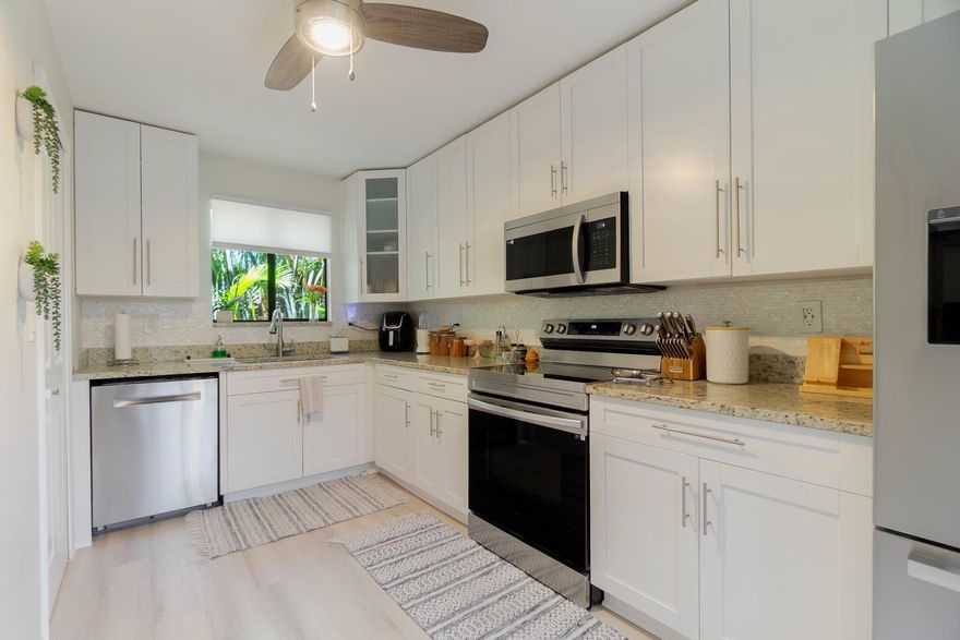 Like new! This beautifully updated 2BR/2BA villa in the heart of Wellington offers exceptional privacy and a modern, move-in-ready feel. It features a brand-new roof, remodeled bathrooms, and wood-like flooring throughout. The open, bright layout includes a nicely upgraded kitchen with stainless steel appliances and a spacious primary suite. The primary bath showcases Italian porcelain tile in the shower and elegant wood accents. A well-sized guest bath brings in natural light and offers convenient hallway access. The private, covered patio, with built-in grill and three-way access, is perfect for outdoor entertaining. Located within minutes of shopping, dining, Wellington Mall, equestrian activities and A-rated schools, all with low HOA fees.