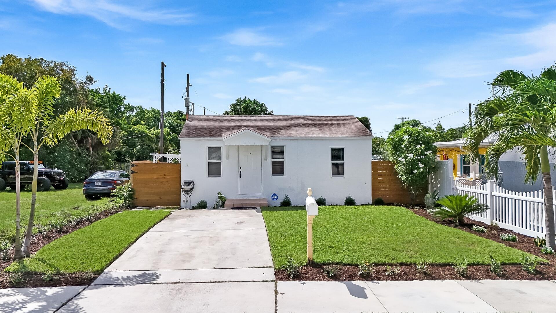 Discover a rare opportunity to lease a piece of Delray's authentic charm. This vintage two-bedroom cottage is an enchanting oasis set against the exciting backdrop of downtown living. Here, a lifestyle of convenience and coastal sophistication awaits. The home offers a comfortable and serene living space, while the grounds provide a private escape unlike any other. The expansive, fully enclosed garden is a verdant sanctuary designed for both tranquil relaxation and memorable entertaining. Mature landscaping, a charming trellis, and dedicated garden space create a picturesque setting for alfresco dining or quiet contemplation. With a private driveway, hurricane-rated windows, and the simplicity of inclusive utilities (excluding internet), every detail has been considered for your comfort.