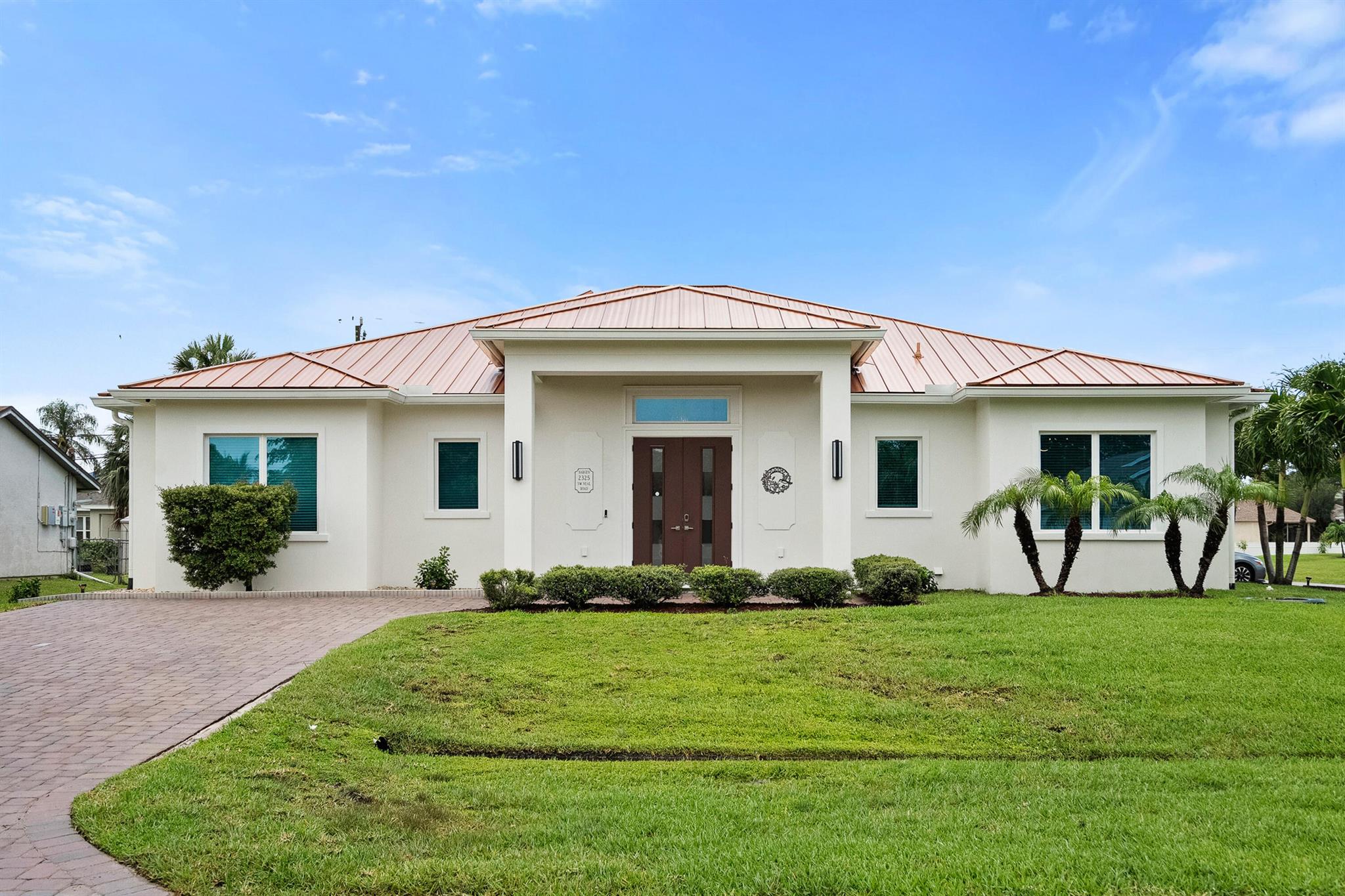 Welcome home to this ''one of kind'' custom-built floorplan built in 2019. Situated on an oversized corner lot with no HOA & 2 driveways this home gives you all the perks of living in tradition without the high HOA fees & extra taxes. Less than 3 miles to Tradition Square & only 53 minutes to the WPB Airport, making it an easy commute for a potential second home. No HOA = bring your boat/RV! Tile wood plank flooring throughout with crown molding & 8 ft interior doors. ALL IMPACT windows & doors with a seamless metal roof. Custom sconce lighting throughout the home with a freshly painted interior. The expansive covered back patio is plumbed & ready for your summer kitchen with a tongue & groove ceiling detail that matches the front entryway. A coastal inspired white & navy shaker kitchen