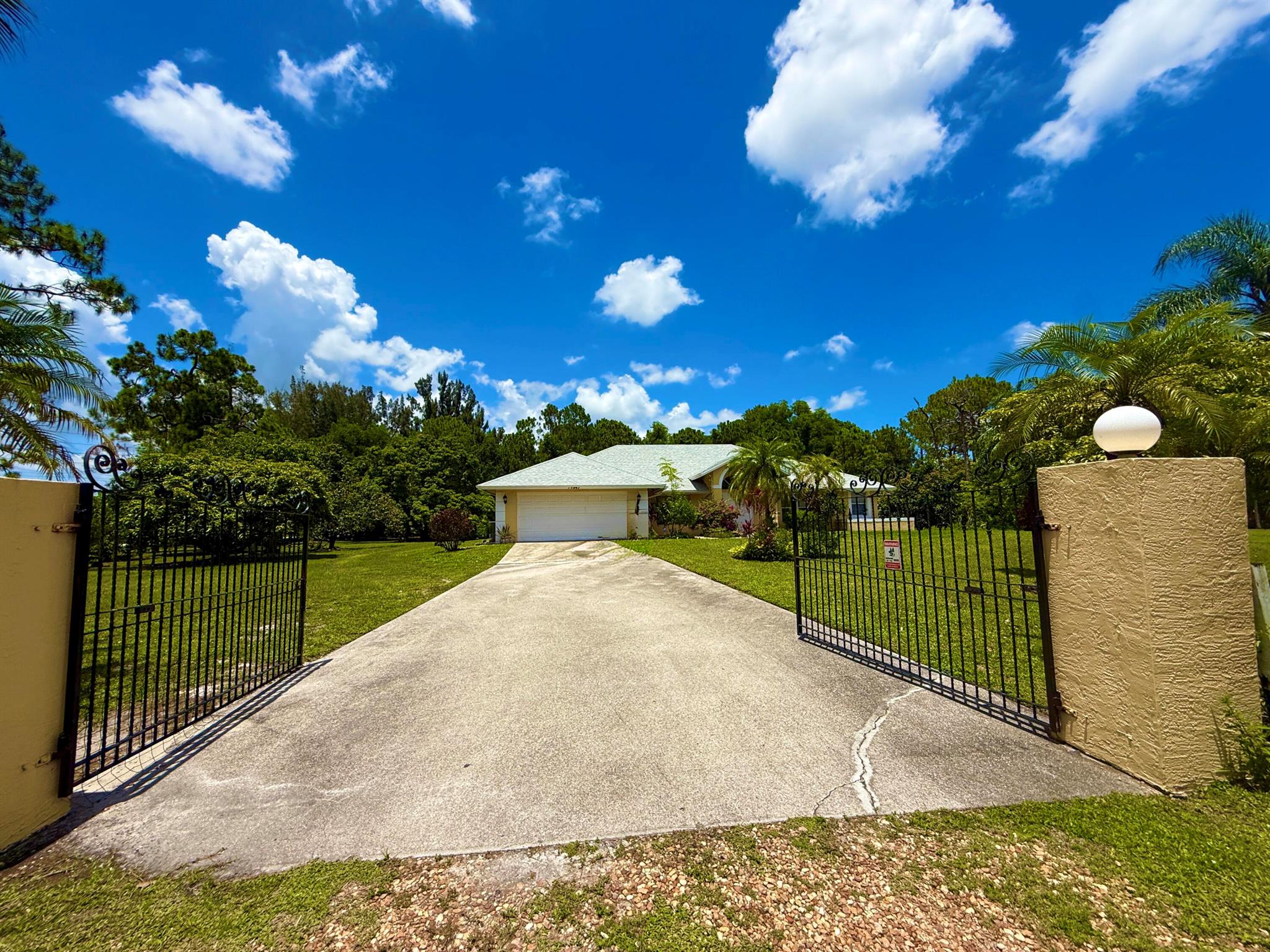 CITY WATER !!! CITY WATER !!! CITY WATER !!! NEW ROOF 2023 !!! CORNER OVERSIZED LOT ****. LARGE CONCRETE DRIVE ** RARE FIND** QUIET and BEAUTIFUL Acreage Community PARK JUST STEPS AWAY** ENJOY A MORNING WALK / JOG on Park with a playground, picnic tables, walking track, and nature trail - Ideal for any family!!!! 2.29 ACRES !! ROOM FOR Pool/ guest house/ In Law Suite/ WORKSHOP **. THE POSSIBILITIES ARE ENDLESS ***. !!!! LOCATION * LOCATION* LOCATION * WELCOME TO YOUR PRIVATE PARADISE AT 13947 63RD LANE, WEST PALM BEACH FLORIDA 33412! NESTLED ON A SPACIOUS LOT IN ONE OF WEST PALM BEACH'S MOST DESIRABLE ACREAGE COMMUNITIES, THIS BEAUTIFULLY UPDATED 4 BEDROOM 2 BATHROOM 2 CAR GARGE plus 4 car detached accessory building and be used storage/ goats/ chickens/ Horses !!!!
