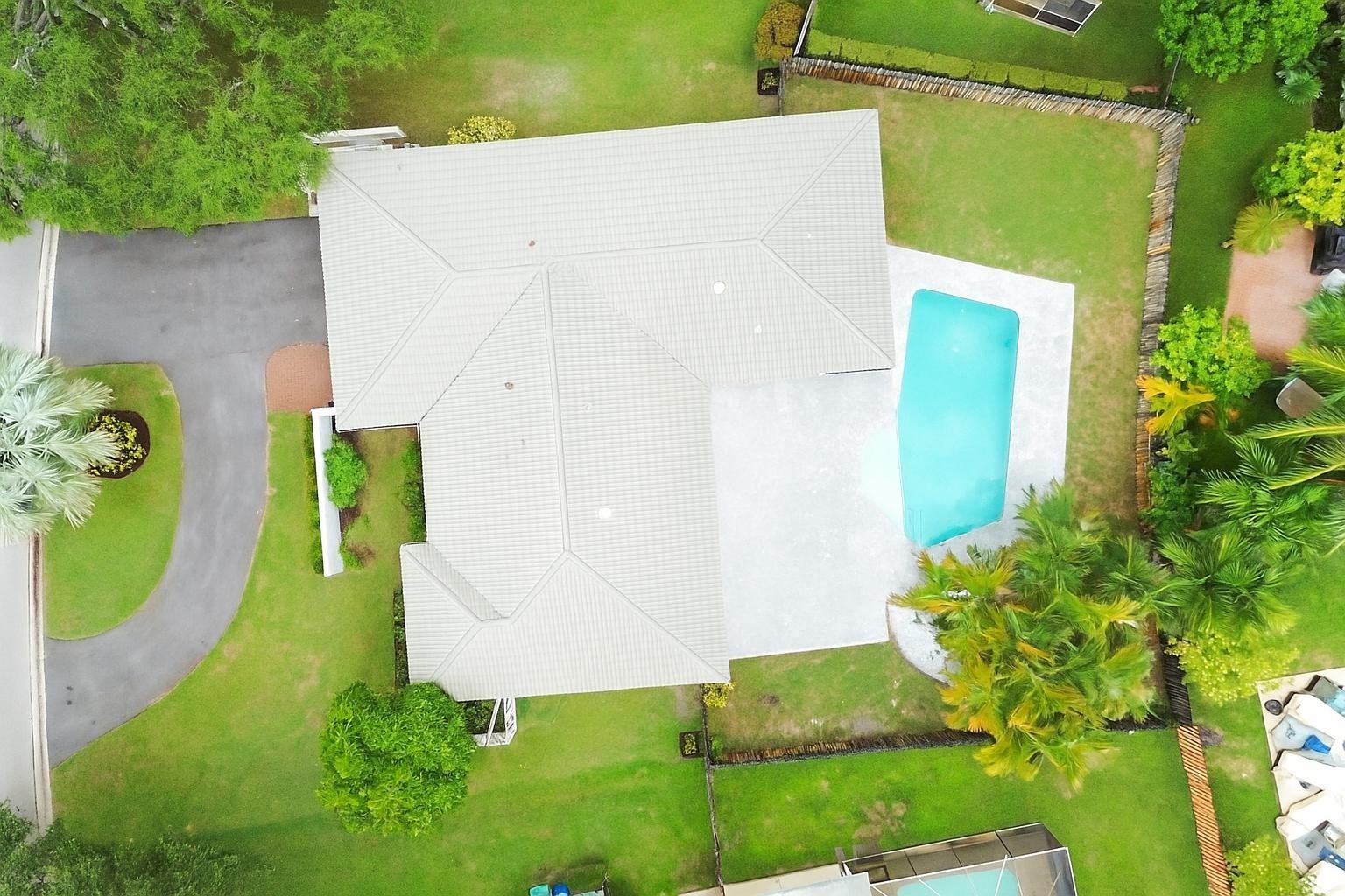 Nestled in a tranquil neighborhood of Maplewood in Coral Springs, this impeccably maintained 4/2.5 home boasts: a remodeled kitchen, with pullouts and turntables, seamlessly connects to a spacious breakfast area, and a split-bedroom design. The screened lanai overlooks a large backyard featuring a pristine pool, travertine pavers, and a 6-foot shadowbox privacy fence, creating a serene retreat. Tastefully remodeled bathrooms provide a contemporary feel, while impact windows and accordion hurricane shutters ensure security. Additional features include abundant storage and a two-car garage, blending practicality with style. This residence epitomizes meticulous care and offers a lifestyle of comfort and sophistication, an exceptional opportunity for discerning buyers seeking their dream home.